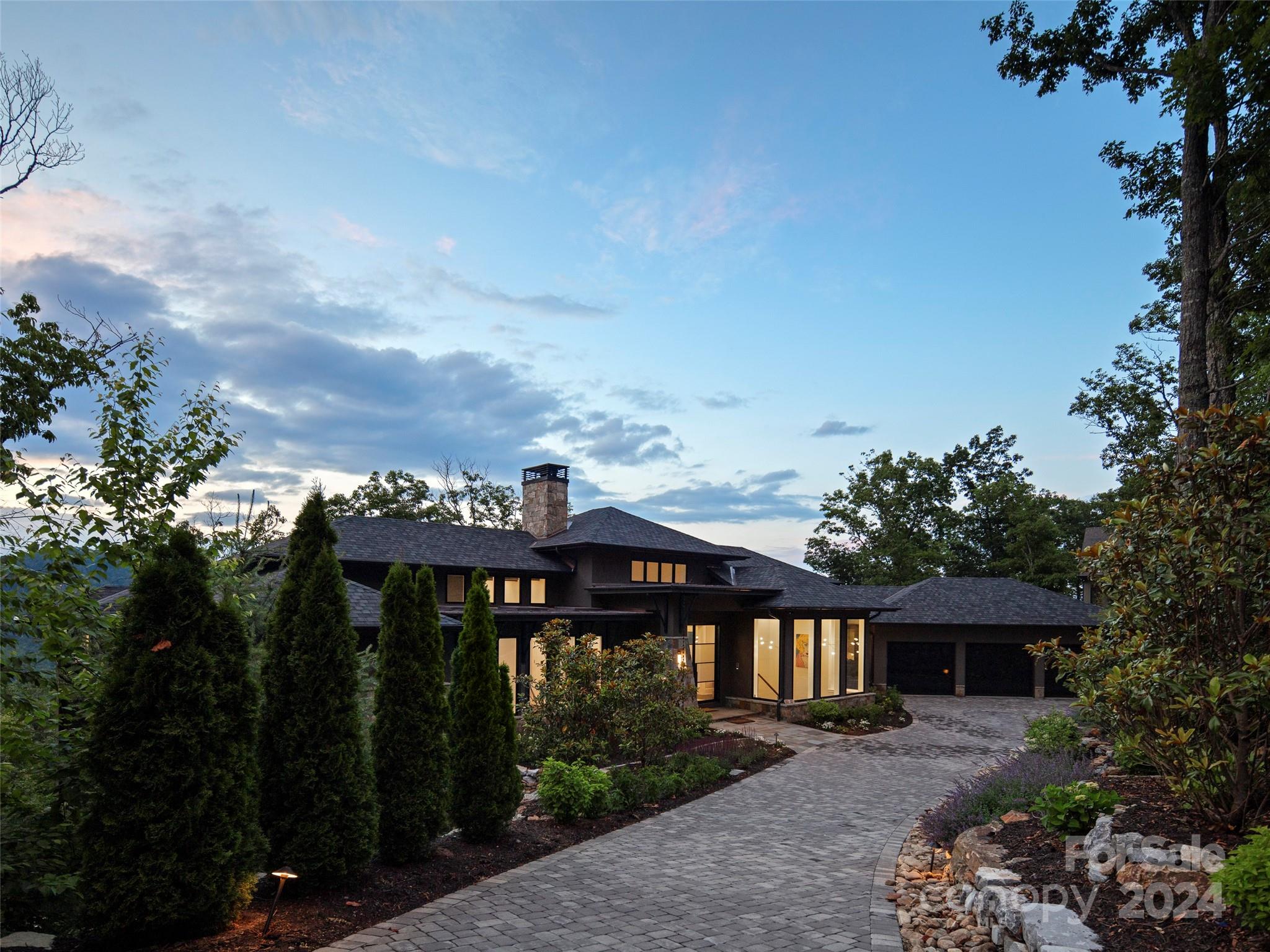 Perched high above The Cliffs at Walnut Cove, this luxurious home offers an exceptional mountain paradise. Indulge in mesmerizing, layered, long-range mountain views, framed by soaring ceilings, glass and stone finishes, and stunning lighting at every turn. Revel in the panoramic vistas of the beautifully lush Walnut Valley and distant Blue Ridge Parkway. Refined elegance defines the interior, featuring a magnificent great room, open kitchen with a commanding island, private home office, and a main level primary suite with a steam shower and dry sauna. Relax on two levels of screened porches and decks, or unwind in the hot tub while savoring the majestic views. The terrace level provides ample space for play, guests, and work, complete with a bar kitchen, billiards and game space, indoor/outdoor dining, laundry, plus fenced level yard space for your pets. This exquisite home offers the best of Walnut Cove living, ensuring you’ll want for nothing. Membership in The Cliffs is available.