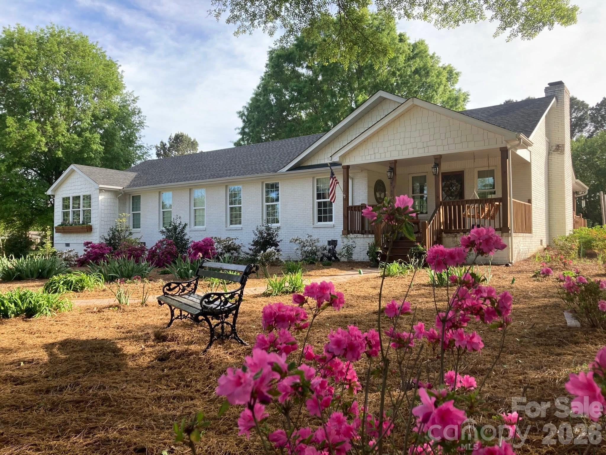 Tucked away on over 7 beautiful, level acres including an adjoining lot, this thoughtfully updated 4-bedroom, 3-bath ranch offers the perfect blend of comfort, space, and outdoor living. Inside, you’ll find an inviting open layout connecting the living, dining, and kitchen areas, creating an ideal flow for both everyday living and entertaining. A charming fireplace anchors the main living space, while generous closet space throughout the home provides functionality rarely found in ranch-style properties.  Step outside and discover a true outdoor entertaining dream, complete with stunning landscaping and endless room to enjoy the peaceful surroundings. The detached garage is equipped with a mini-split air conditioning system, making it perfect for a workshop, hobby space, home gym, or additional entertaining area. With expansive acreage, modern updates, and a setting that offers both privacy and possibility, this property is a rare opportunity to enjoy country living with style and convenience.