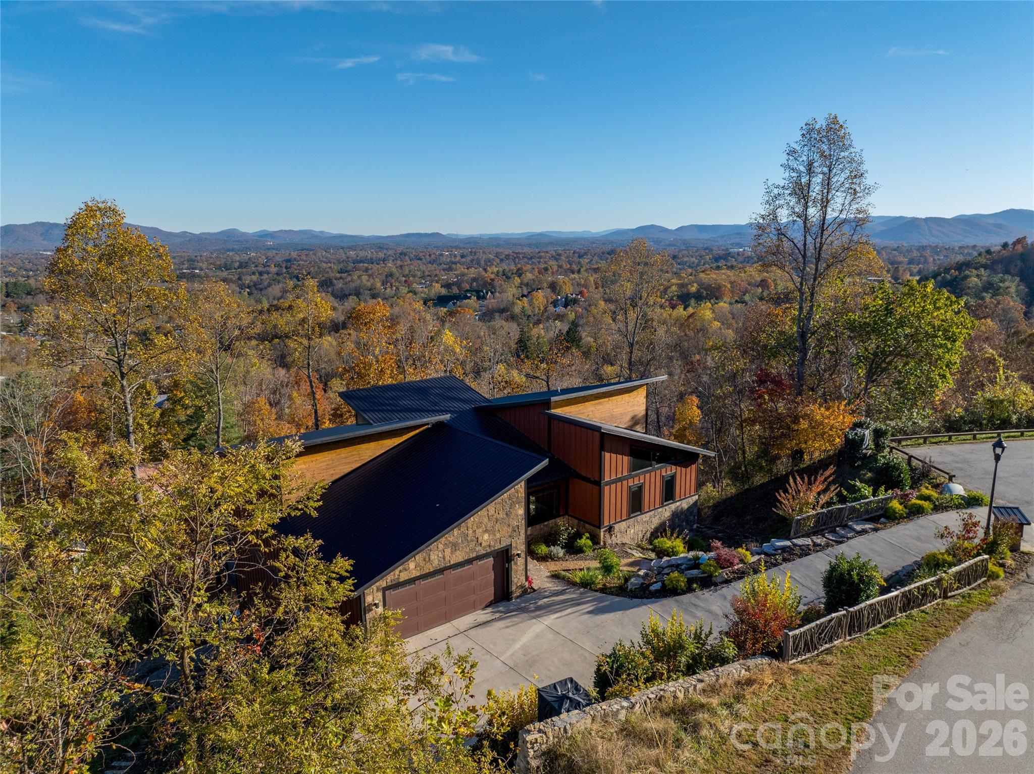 An incredible value. Now priced well below tax value. Pre-inspected and in excellent condition! Enjoy the ever changing, breathtaking views as the four mild Asheville seasons explode with color and inspiration from every window and deck of this magnificent custom estate residence. Experience refined mountain living where privacy, craftsmanship, and thoughtful design come together in one of Asheville's most peaceful settings. Tucked away just beyond the gate on a quiet street this home offers a rare combination of seclusion and easy access to downtown. Built with emphasis on quality materials, efficiency and lasting construction the home showcases upscale finishes and a well considered layout with elevator access to all three levels that feels both elegant and comfortable. Natural light flows through the living spaces highlighting the attention to detail and creating a seamless connection to the surrounding landscape. Each space is designed to feel intentional, functional and inviting. The setting is equally impressive, lush, private and tranquil providing a true sense of retreat. Whether enjoying a quiet morning surrounded by nature or entertaining guests in a relaxed, elevated atmosphere, this property offers flexibility for full time living, a refined second home or a high end investment. Priced below appraised value for investment peace of mind and waiting to welcome you home.