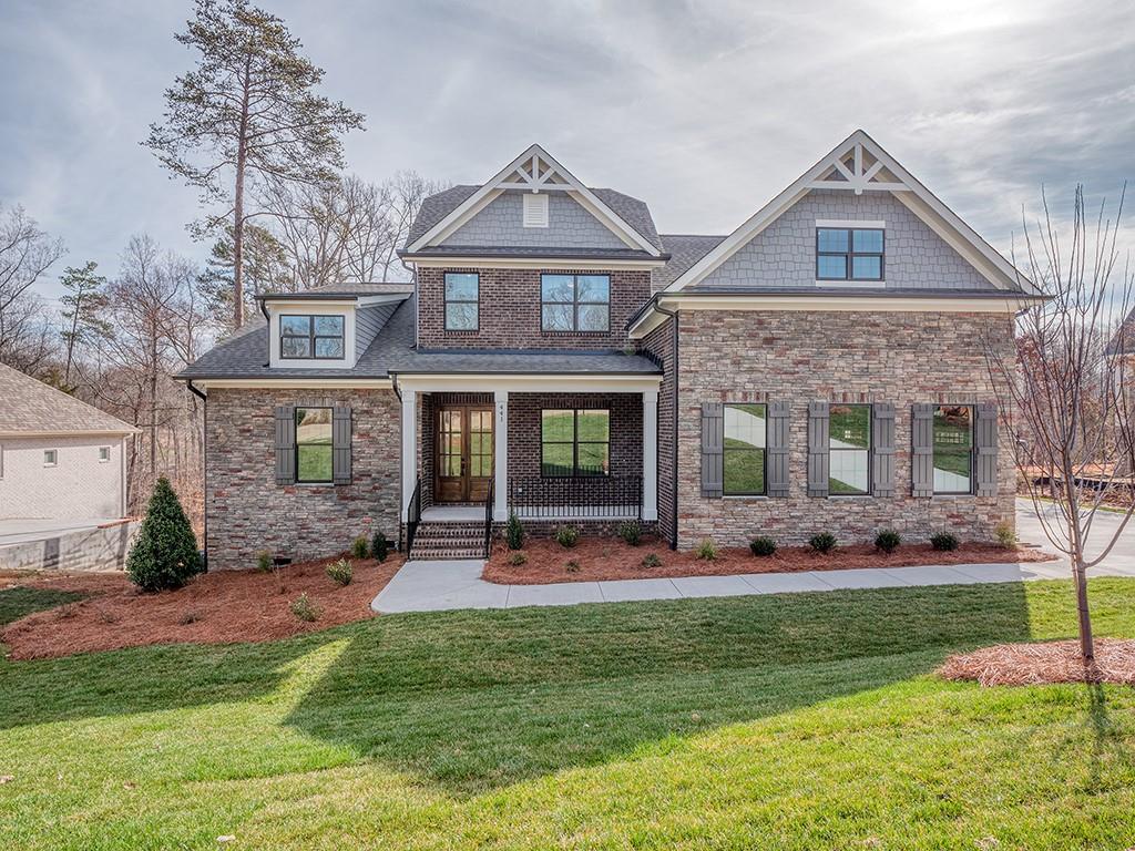 This beautiful new brick home is constructed on one of the last lots in the established lake front community, The Retreat at Sunset Ridge. The exterior features .768-acres with a pool friendly large rear yard that gently rolls to the end of a Lake Wylie cove to launch your kayak.  The interior features a primary on main, 4 bedrooms, 4 baths, spectacular open kitchen, upgraded cabinets and counter tops, Kitchenaid appliances, heavy trim, a large bonus room, mud room with drop zone, first floor laundry room, and a great covered deck to take in the mature hardwoods.  The Retreat at Sunset Ridge is one of Lake Wylie's premier custom home communities, featuring a quiet atmosphere, a community pool with clubhouse, and just minutes from limitless recreation opportunities at the lake.  Top rated Clover schools and proximity to great restaurants and shopping makes this the perfect home to start the new year. The home is complete and ready to move in!