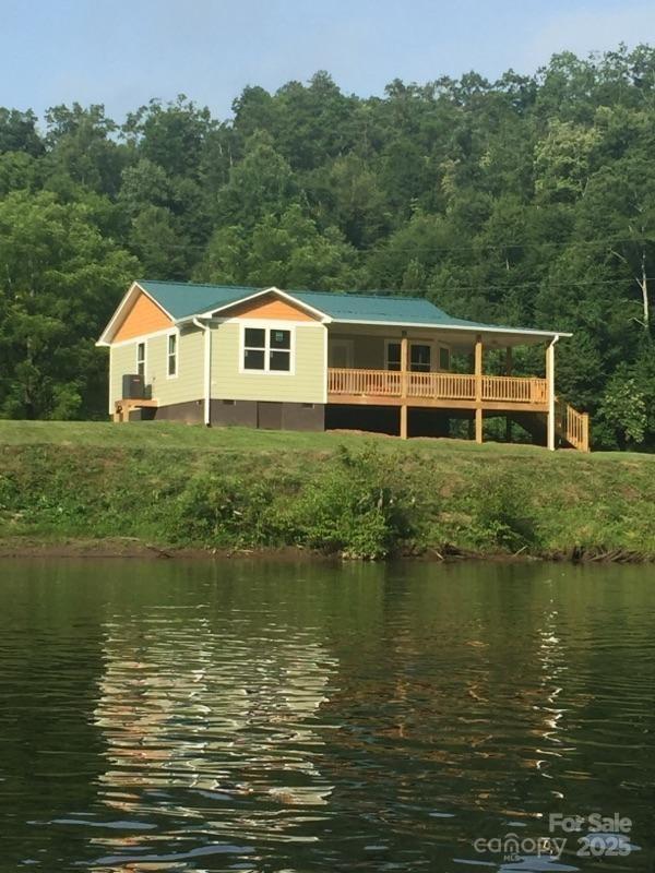 This is a super, well kept home.  A river facing Hot tub that is overlooking the Tuck river.   Wrap around covered front porch and highlights a bay effect windows in the great room that also overlooks the river.  The back deck allow easy access to parking and quiet area to sit in the sunshine.  Both bathroom are full baths with access from the bedroom of choice.  HOA is solid and easy to work with.  A community well offers a reliable water supply.  Looking for a mountain home with access to one of the best trout rivers, close to Cherokee casino, and multiple vacation designations? This is your dream home.  Don't hesitate because this is priced to sell.