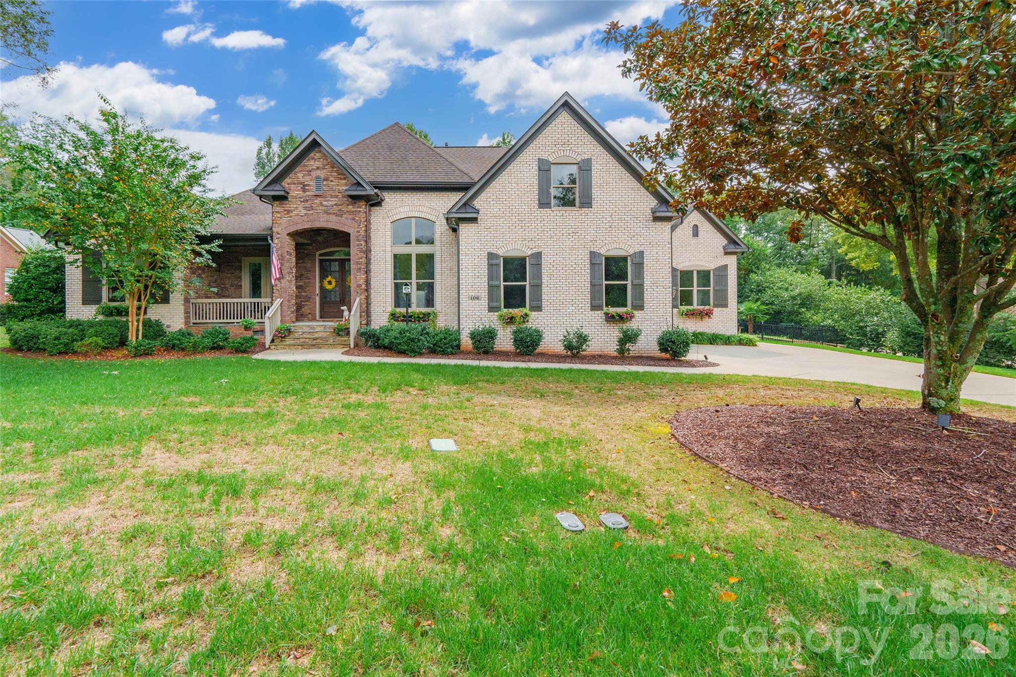 Experience unparalleled elegance in this exquisite brick ranch home by Shea Homes, featuring the Custom Sullivan plan. Enter through the charming covered front porch into a bright, open layout enhanced by transom windows & wood floors. The dining room exudes sophistication w/its elegant wainscoting. The kitchen boasts granite countertops, SS appliances & a double oven, seamlessly flowing into the great room, where impressive cathedral ceilings & a gas log fireplace await. The butler’s pantry has been transformed into a wet bar, perfect for entertaining. Retreat to the primary bdrm, complete w/walk-in closet & wood beam accents, leading to a ensuite BR w/an oversized shower & garden tub. Step outside to the back porch w/ wood floors overlooking a custom concrete saltwater pool & fenced backyard. Additional highlights: steam humidification system, outdoor irrigation, 11.4 KW solar panels & all within the coveted Fort Mill school district! Come check out this immaculately maintained home!