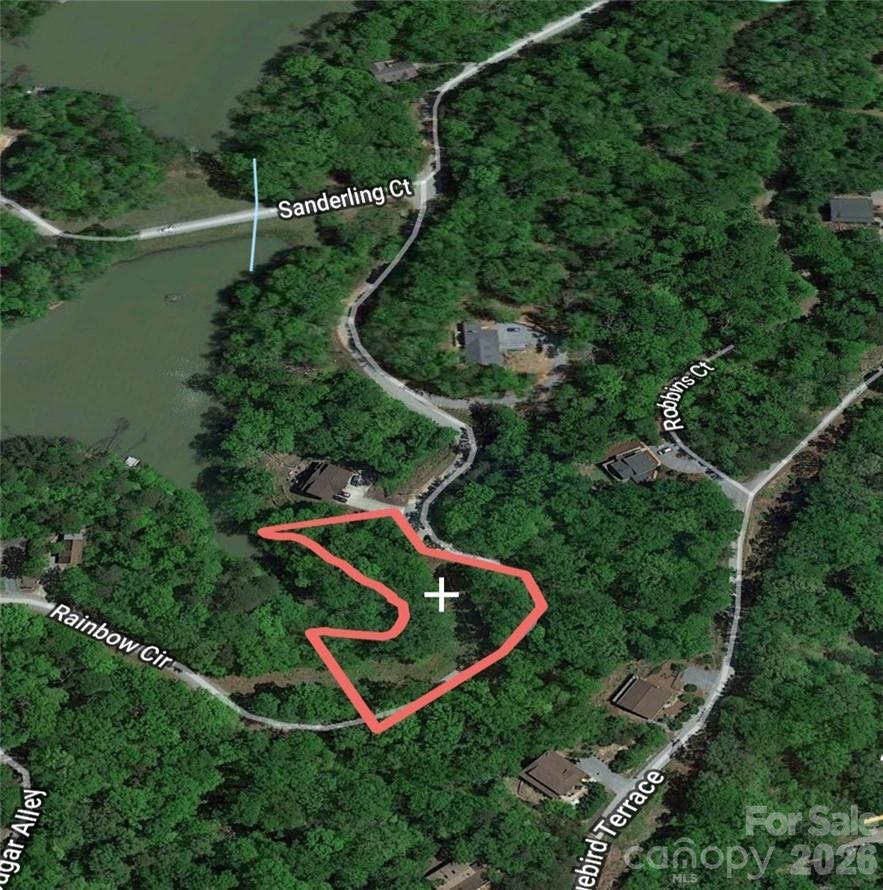 Waterfront Lot on Little Mirror Lake – Riverbend at Lake Lure... Close to Lake Lure | Chimney Rock | Tryon International Equestrian Center. Rare opportunity to own a gently sloping waterfront lot on Little Mirror Lake, nestled in the private, gated Riverbend Community of Lake Lure. This beautiful property offers a perfect blend of privacy, natural beauty, and convenience—a true gem that's becoming harder to find in this sought-after region.
Enjoy serene lakefront living with a mix of gentle contours and flat areas ideal for building your dream home or vacation retreat. A septic permit is already in place, saving you time and expense as you move forward with your plans. Riverbend is known for its natural mountain charm and exclusive amenities. Residents enjoy two private lakes, a swimming hole with waterfall, walking trails, and scenic areas for hiking, kayaking, canoeing, fishing, and picnicking. With gated access, you'll enjoy peace of mind and the tranquil privacy of a close-knit community.
Located just minutes from Lake Lure, Chimney Rock State Park, and the Tryon International Equestrian Center, this property also offers convenient access to local dining, shopping, and airports in multiple directions—making it both a secluded escape and a perfectly connected base. Waterfront lots like this are rare—especially ones that offer the right balance of gentle topography, natural beauty, and community perks. Whether you're looking for a vacation retreat, a year-round residence, or a smart investment, this lot checks all the boxes.
Buyer must be accompanied by a licensed agent to access the gate.
One-time certification fee of $195 due at closing (buyer responsibility).
Don’t miss your chance to claim a coveted waterfront slice of the Lake Lure lifestyle!