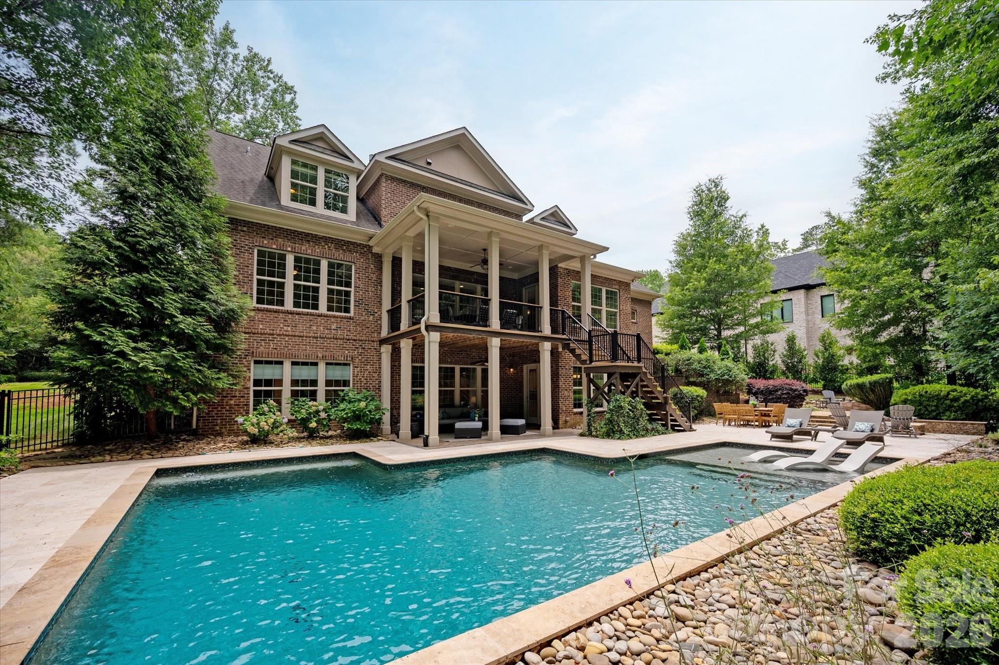 Luxury, accessibility, and multi-generational living converge in this exceptional custom brick estate featuring over 6,700 square feet of beautifully appointed living space and a resort-style backyard retreat. This expansive home features an open-concept floor plan with beautiful hardwood floors throughout the main living areas and a stunning chef's kitchen complete with a large center island, updated backsplash, coffee bar, and sunny breakfast area.
The main level offers the convenience of both a luxurious primary suite and a private guest suite, making everyday living effortless. Upstairs, you'll find four additional bedrooms with new carpet, and a bonus room.

The fully finished walkout basement functions as a complete second living quarters featuring two bedrooms, 2 full bathrooms, a full 2nd kitchen, a 2nd laundry room, and living room and sitting room with a fireplace. An elevator provides seamless access between the main level and basement, making this home ideal for multi-generational living, long-term guests, or accessibility needs. 

Step outside to your own private outdoor oasis, where entertaining is easy with a spacious deck, covered patio, PebbleSheen saltwater pool, and two fire pit areas. Additional highlights include a 3-car side-load garage, abundant storage, and exceptional indoor-outdoor living spaces. Zoned for sought-after Marvin schools!