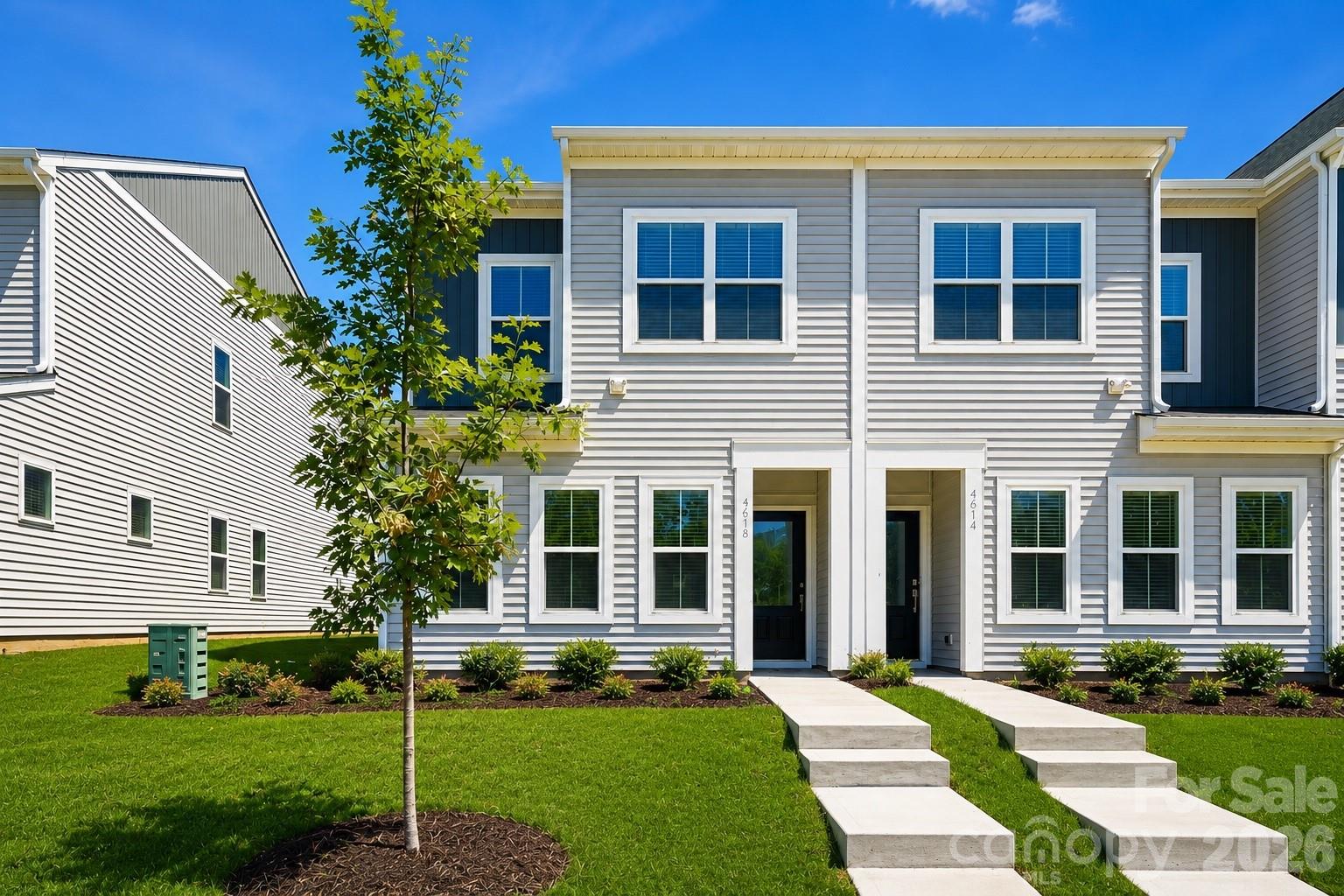 Spend less time on maintenance and more time enjoying life in this beautifully crafted townhome by award-winning Mungo Homes, located in the sought-after Lakeview Village community. Designed for today's lifestyle, the thoughtfully crafted open floorplan features soaring 9-foot ceilings, luxury vinyl plank flooring, designer finishes, and exceptional storage throughout. The gourmet kitchen serves as the heart of the home with quartz countertops, soft-close cabinetry, stainless steel GE appliances, and a spacious center island perfect for entertaining. Just off the rear-entry garage, a dedicated mudroom adds everyday convenience and functionality. Upstairs, retreat to the luxurious primary suite featuring an elegant tray ceiling, oversized walk-in closet, and a spa-inspired bath complete with quartz countertops, dual vanities, and a beautifully tiled walk-in shower. Residents enjoy the ease of low-maintenance living with exterior maintenance included, community sidewalks, and a neighborhood dog park. Conveniently located just minutes from Uptown Charlotte, Riverbend Village, Northlake Mall, Charlotte Douglas International Airport, I-77, and I-485, Lakeview Village offers the perfect blend of comfort, convenience, and modern living. Ask about current builder financing incentives and move-in promotions.