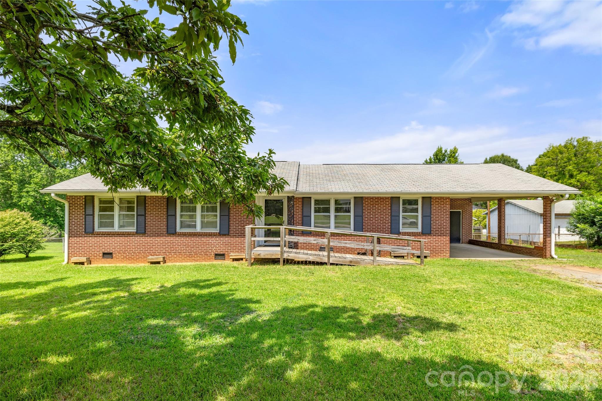 Welcome to this well-loved one-story brick ranch, waiting for you to create the home you've always envisioned. Nestled on a generous .66-acre lot, this 3-bedroom, 1.5-bath home offers the timeless appeal of solid brick construction, a functional floor plan, and exceptional potential for modern updates. Step outside to enjoy the spacious, fenced backyard—perfect for pets, gardening, entertaining, or simply relaxing. A true standout feature is the 532 square feet wired, detached workshop with its own welcoming covered porch, providing endless possibilities for woodworking, hobbies, artists, projects, storage, or even a creative studio. Whether you're a first-time buyer or someone looking for a home with great bones and room to make it your own, this one-owner property is a rare find. With its generous lot, versatile workshop, and great potential,  this home is ready for its next chapter and the memories yet to come.
