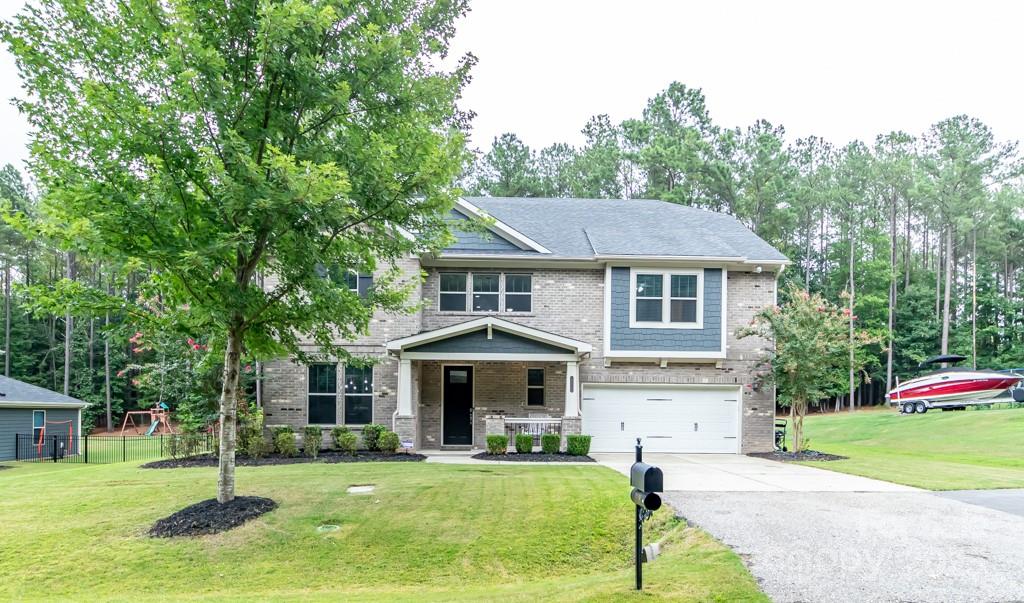 BACK ON THE MARKET, SELLERS AT NO FAULT, BUYERS GOT COLD FEET.  REQUESTED REPAIRS MADE!  Rocking chair front porch on this custom-built Craftsman style home, less than a mile from Allison Creek boat landing! Spacious open floor plan, gorgeous rich looking dark flooring, lots of molding, tray ceilings, and arched doorways throughout.  Fenced backyard backs to thick woods offering privacy with a huge patio great for entertaining!  Gorgeous chef kitchen with a huge island, gas cooktop, SS appliances, granite counter tops, and a butlers pantry leading to a dining area with a tray ceiling. Great room is extremely spacious with glamorous built-ins. Primary suite features a large sitting area perfect for an office space. Primary bathroom has a soaking garden tub and stand up shower with an extra large walk-in closet. 3 car tandem garage with enough room for a work shop. Tankless water heater for endless hot water.  Energy Star Qualified certificate. Great Clover schools with low SC taxes.