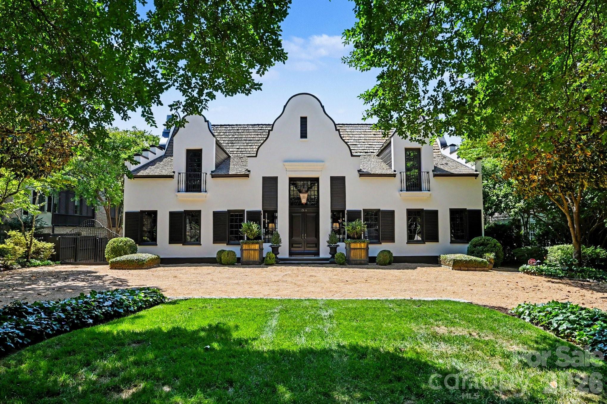 An extraordinary residence on prestigious Queens Road West in Myers Park, originally designed by renowned designer, Bobby McAlpine and built by Philip Thomas. This exceptional 4-bedroom, 5.5-bath home masterfully blends timeless Cape Dutch architecture with sophisticated modern refinement. Thoughtfully curated interiors showcase soaring ceilings, rich hardwood floors and beautifully proportioned living spaces. Indoor-outdoor living unfolds effortlessly from the main entertaining areas to the covered porch and Bluestone patio. At the heart of the home, the impeccably updated chef’s kitchen combines striking design with exceptional functionality. The beautiful dining room flows seamlessly into the family room. The main-level primary suite features a steam shower. Upstairs, each secondary bedroom features its own ensuite bath. A detached two-car garage is crowned by a private guest apartment, adding flexibility for guests or a private studio retreat. The fully fenced backyard includes an EVO Grill with custom stainless steel cabinetry by John Michael Studio. Perfectly positioned near Freedom Park and the acclaimed dining and shopping along East Boulevard, this is a rare opportunity to own a truly distinctive property in one of Charlotte’s most sought-after locations.

Please see notable features and upgrades in the MLS attachments. Too many to list!

Refrigerators, washer and dryer, TV mounts, and Art TV in family room convey.