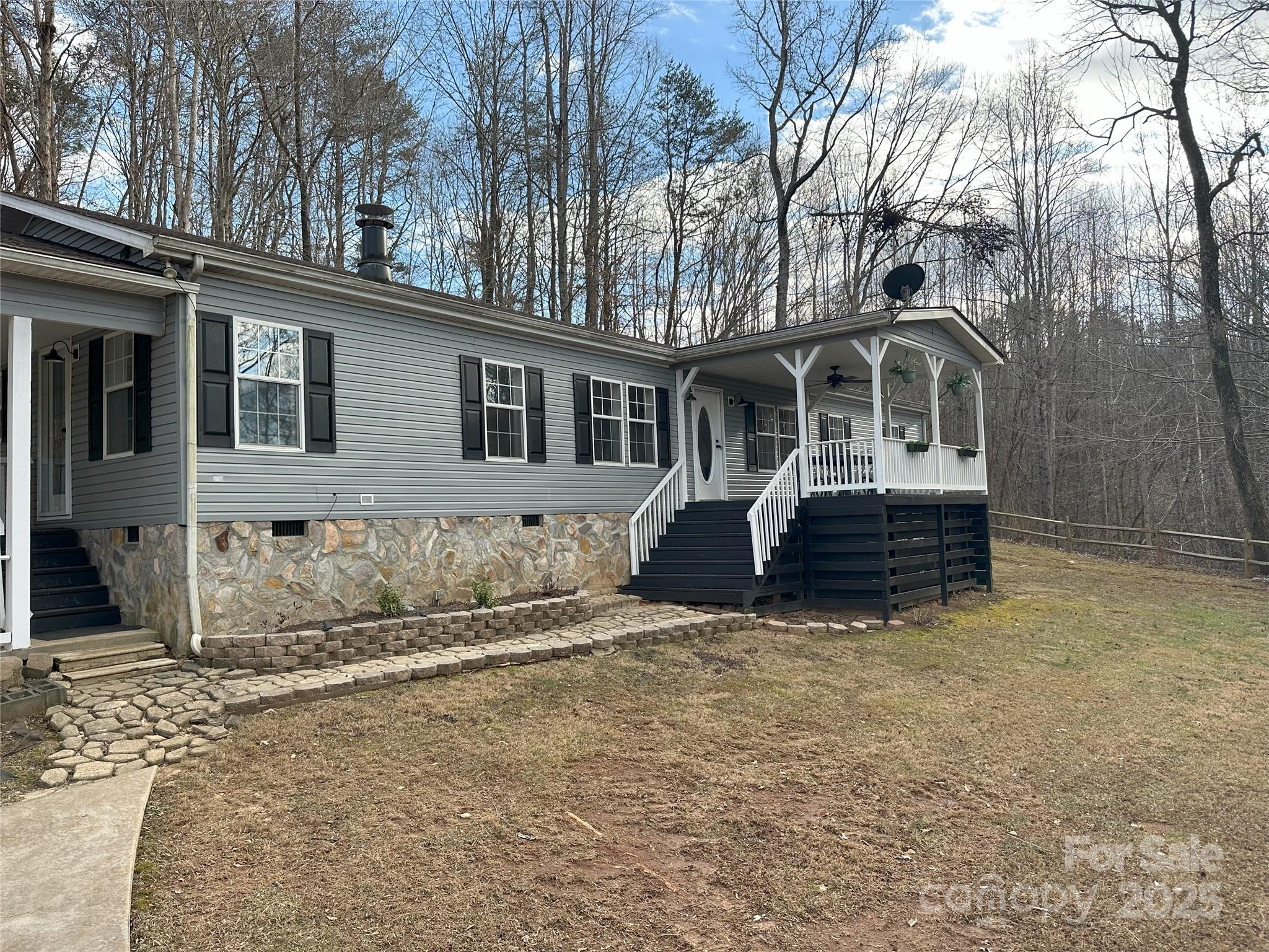 Situated on 6+ acres this 3 bed/2 bath home is a perfect retreat for a homeowner or continued use as a successful AirBnb.  Open concept from the kitchen to the living areas accommodates large gatherings around the gas log fireplace.  Or enjoy the covered front porch or back yard covered porch and firepit.  Home offers new roof and vinyl, LVP flooring, new stove and microwave.  Paved drive with a large 2 car carport and multiple parking options. Lower fenced entrance has room for more short-term parking with electric hookup. Located directly across from the Cleghorn Golf and Sport Club, less than 10 min from Tryon International and next door to Broad River Access for paddling, swimming and fishing. This property is part of River Ridge HOA which offers gated access to the Broad River, with private common areas and picnic tables.