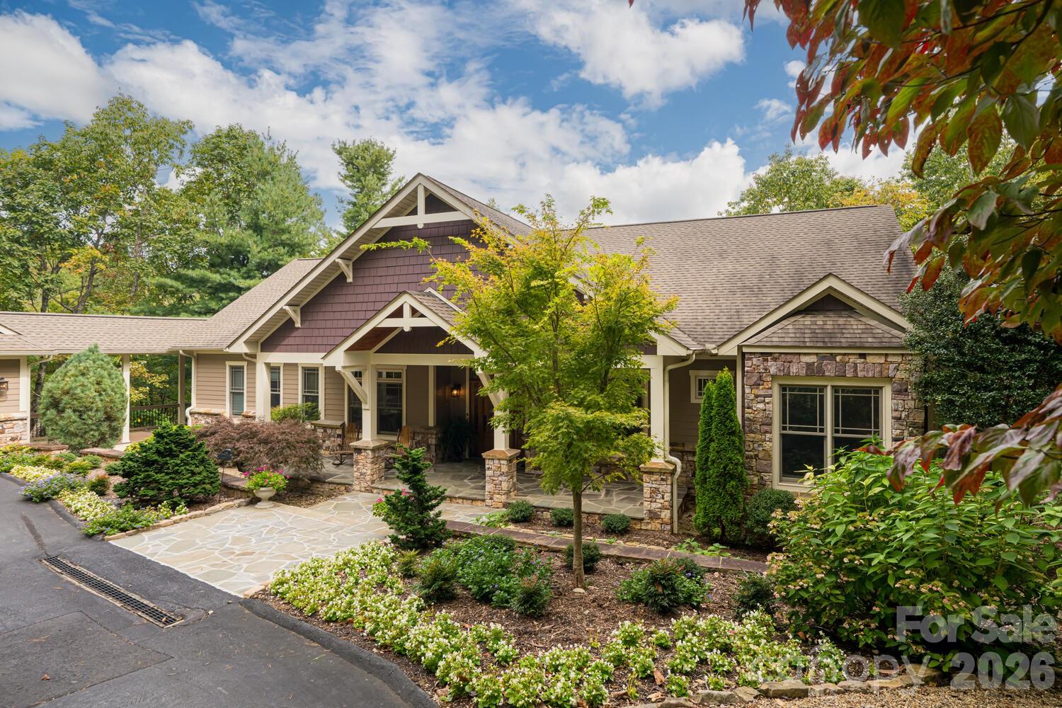 Luxury Mountain Architectural Masterpiece with Unmatched Detail. Absolutely stunning high-end home showcasing exquisite architectural detailing throughout. From the moment you arrive down the private driveway you’ll be captivated by the covered slate-floored front porch, meticulous landscaping and stone hardscape with pebble pathways winding through the property. Step inside to a great room featuring a coffered ceiling, gas fireplace and expansive sliders that frame the natural setting. The gourmet kitchen is a perfect blend of form and function offering a large island with prep sink, abundant custom cabinetry, premium appliances, gas cooktop with designer hood and every amenity for effortless entertaining. A butler’s pantry with wine bar complements this amazing kitchen. The elegant tray ceiling dining room bathed in natural light from large windows overlooks the gorgeous landscaping. The primary suite is a serene retreat with a gas fireplace, two custom walk-in closets and a luxurious spa-like bath with freestanding tub, double granite vanity and stunning walk-in tiled shower with pebble floor. There is a spacious laundry room/ mudroom area. Completing the main level is a great cathedral-beamed ceiling sunroom/den, a huge screened porch with gas fireplace and expansive deck- perfect for gatherings or quiet moments surrounded by nature. The lower level offers a recreational and billiards room with bar, stone gas fireplace, large study, two guest rooms, 2 full baths, exercise room and cozy sitting area. There is also a 530 SQFT unfinished storage space. Expansive 3 car garage. Enjoy the beautiful landscaped setting while relaxing on the covered slate-floored patio overlooking the incredible koi pond and waterfall- a true outdoor sanctuary. With unmatched craftsmanship, magical landscaping and sophisticated design throughout, this home is more than a residence- it’s a mountain masterpiece.