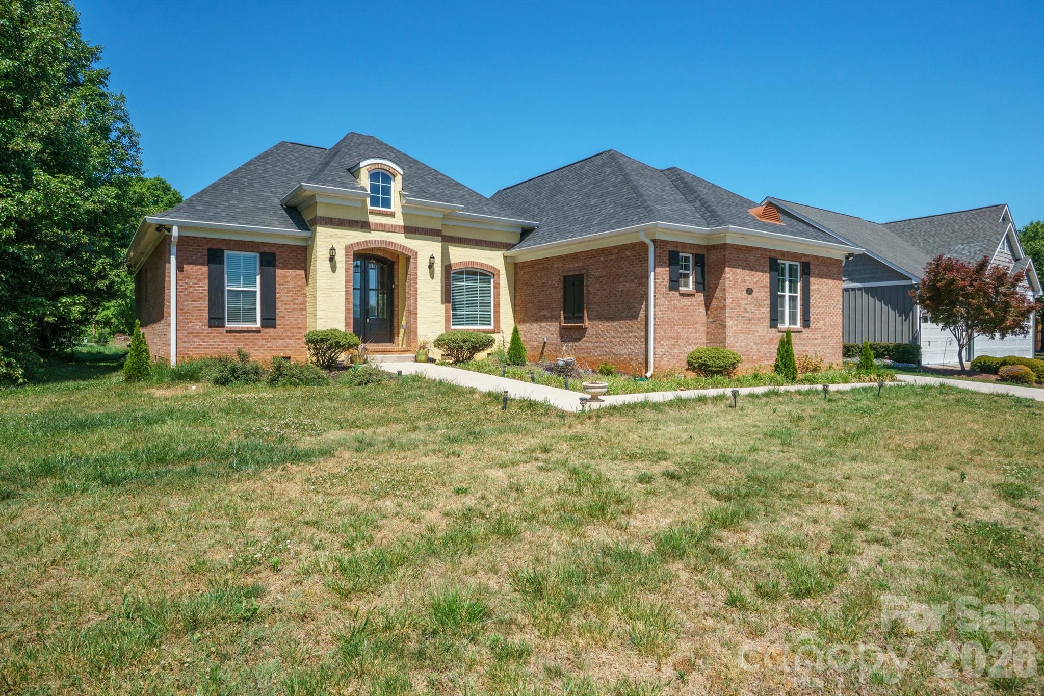 Location, location, location. Homes in this desirable subdivision rarely become available.
This almost-new 3-bedroom, 2-bath brick ranch offers the perfect blend of quality, style, and thoughtful upgrades throughout. From the moment you walk in, you’ll notice the attention to detail—starting with a custom kitchen featuring beautifully crafted cabinetry, granite countertops, a large island, and a breakfast nook, plus space for a full dining area. The upgrades continue beyond the kitchen. The living room, laundry room, and primary bath all feature matching custom cabinetry with granite tops, creating a cohesive and elevated feel throughout the home.
The spacious primary suite offers vaulted ceilings, a large walk-in closet, and a spa-like bathroom complete with a soaking tub, double vanity with granite countertops, and a separate shower.
Enjoy LVP floors throughout—no carpet in any room—along with a stunning double front door that makes a lasting first impression. Situated on a corner lot with a large two-car garage, this home truly checks all the boxes. A rare opportunity in a sought-after location.