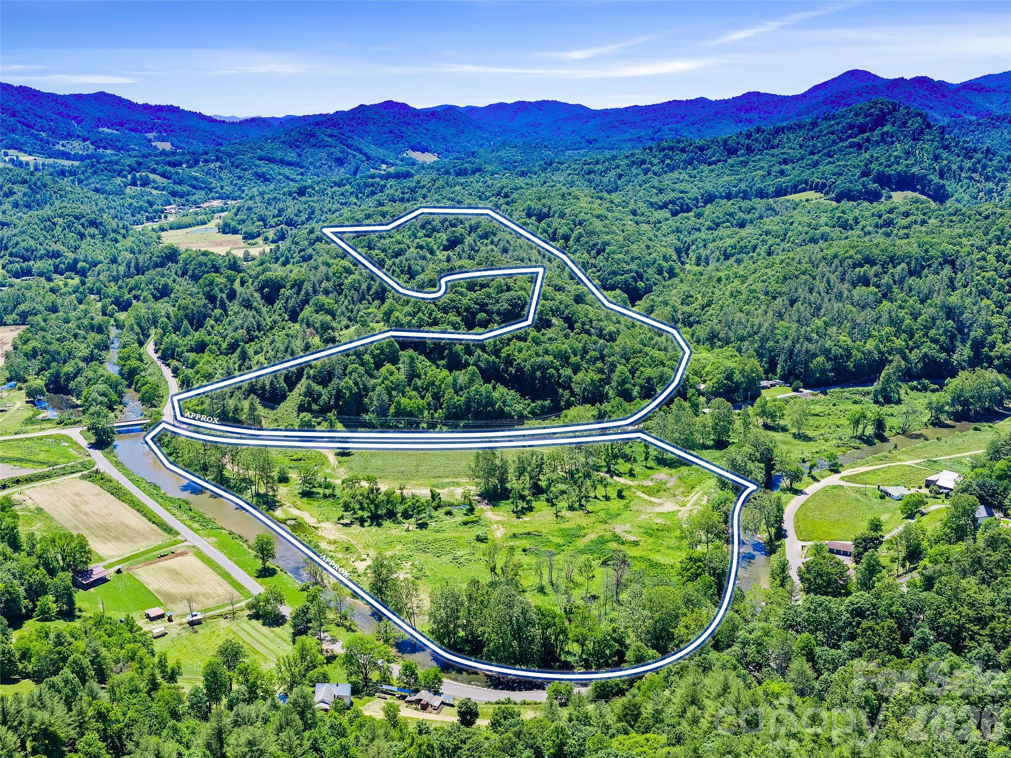 Rare opportunity to own approximately 38± acres of stunning Western North Carolina land just 10 minutes from Burnsville along the scenic Cane River corridor on US Hwy 19W. This property offers the best of two worlds: approximately 18 acres of flat, open bottomland with direct Cane River frontage, and approximately 20 acres of wooded mountain terrain featuring multiple building site candidates, long-range Blue Ridge views, and genuine seclusion. The wooded parcel boasts a winding drive through mature hardwoods leading to natural clearings with sweeping layered mountain views in multiple directions. The river parcel offers wide-open space rarely found in the mountains, with direct water access and a stunning pastoral backdrop. Whether you're envisioning a private estate, family compound, recreational getaway, or long-term land investment, this 38-acre offering delivers versatility, natural beauty, and unmatched WNC character. This property is available as a whole or may be purchased as two separate parcels. See MLS #4390603 (20± acres) and MLS #4390580 (18± acres) for individual listings.