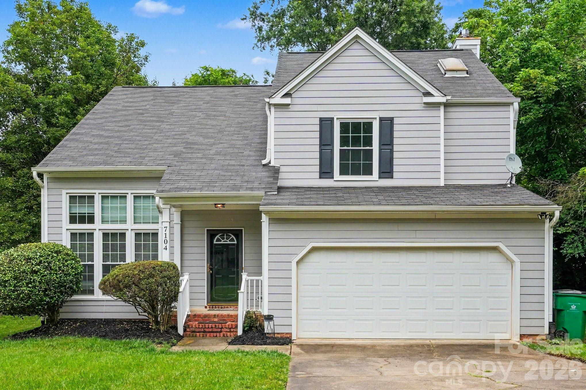 Nestled on a private, wooded lot, this spacious two-story home offers the perfect blend of comfort, character, and modern updates. Step inside to find gleaming hardwood floors, elegant crown molding, decorative wainscoting, and multiple living spaces designed for everyday living and entertaining. The main level features a formal living room, formal dining room, and an inviting family room with a cozy fireplace and French doors leading to the rear deck. The bright kitchen offers stainless steel appliances, abundant cabinetry, generous counter space, and a sunny breakfast area overlooking the backyard. Upstairs, the oversized primary suite boasts a vaulted ceiling and a beautifully renovated spa-inspired bath featuring a dual-sink vanity, marble-look flooring, glass-enclosed shower, and soaking tub. Three additional bedrooms provide ample space for family, guests, or a home office, while the secondary bath offers a convenient tub/shower combination. Enjoy outdoor living on the rear deck surrounded by mature trees and peaceful green space, creating a private setting perfect for relaxing or entertaining. Additional highlights include a laundry room, updated bathrooms, fresh neutral finishes throughout, and abundant natural light. A wonderful opportunity to own a move-in ready home with generous living space, timeless architectural details, and a tranquil backyard setting.