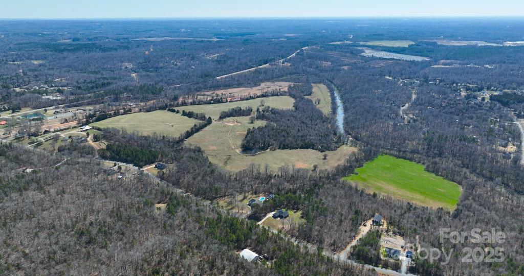 Discover a rare opportunity to shape a premier residential community in one of Concord’s most sought-after and fast-growing areas. This expansive ±138 acre property offers the perfect balance of seclusion, natural beauty, and accessibility. Tucked away in a peaceful, wooded setting, the land features miles of scenic frontage along the Rocky River, providing a serene and picturesque backdrop, ideal for a thoughtfully planned neighborhood. Despite its quiet atmosphere, the property offers easy access to Highway 601, placing future residents just minutes from schools, shopping, dining, and major commuter routes. With gently rolling terrain, mature trees and riverfront vistas, the possibilities are endless. Whether you're envisioning a luxury gated enclave, estate-style homes, or a master-planned community that embraces and enhances the natural landscape, this is a blank canvas for your vision. Additional parcels available for a total of ±278 acres. Access is only available via a scheduled and approved showing.