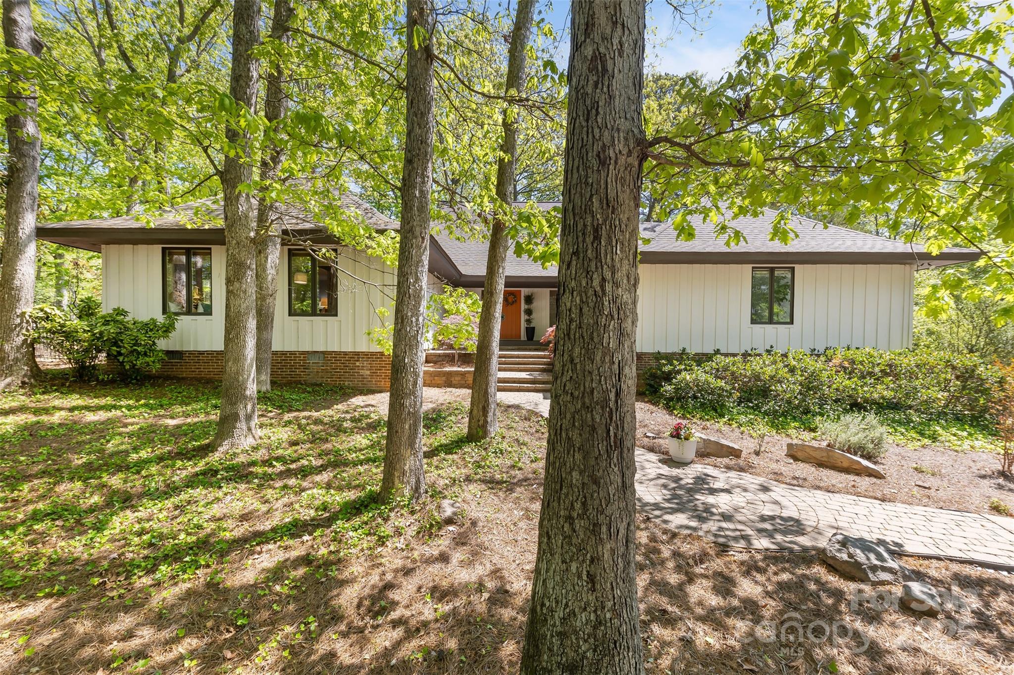Now THIS is a one-of-a-kind, custom home on the 9th fairway of River Hills Country Club. A beautiful blend of mid century modern w/contemporary home that combines resort-style living w/unique design & craftsmanship. Every aspect of this home was designed for entertaining from wrap around deck to split bedroom plan. Large foyer sets the vibe w/Spanish terracotta tile floors, plaster finish walls, & arched entryways. Expansive entry to sunken great room w/a wall of windows overlooking the greens & beautifully framed fireplace. Kitchen offers SS Viking appliances, granite, center island w/gas cooktop & breakfast bar & dining that opens to the expansive deck! Main level offers 3 large bedrooms & 2 full baths, including a versatile owner's suite ideal as guest or in-law suite, w/generous closet space OR home office. Upstairs, retreat to a private primary suite w/fireplace & spa-like bath including huge walk-in shower, dual vanities, & even a personal sauna. Come home to a resort, everyday!