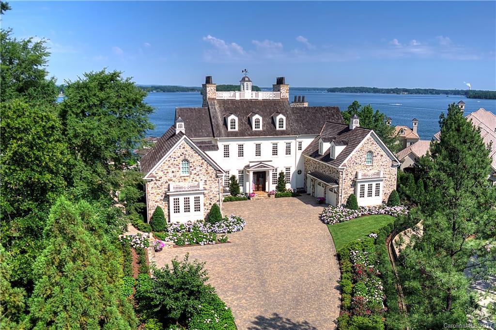 Appeal & character of the New England coast on this Lake Norman estate. Private gated drive, lush landscaping, a gardener's paradise. Wide open, long range, panoramic views. Exquisite craftsmanship & millwork throughout this light filled open floor plan. Elevator services all 4 levels. Meandering terraces w/phantom screens. Potting Shed, Greenhouse, 3 Hidden Staircases, Rooftop Viewing, Private Pier. Every inch of this house is filled with amazing details. See attached features.