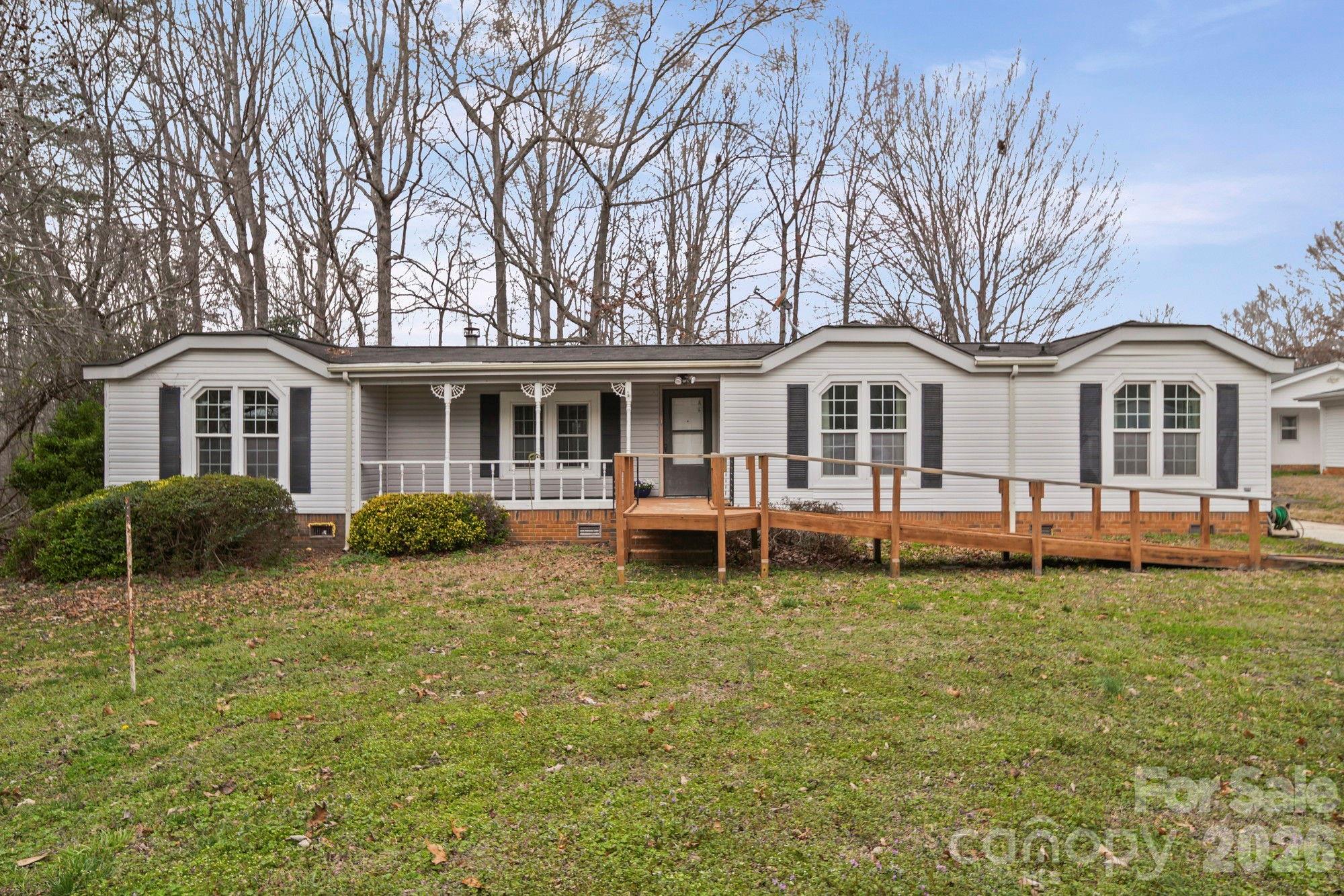 Charming 3-bedroom, 2-bath manufactured home offering spacious living and plenty of potential! Situated on a generous lot, this home features a welcoming front porch with a convenient ramp for easy access and a large screened porch—perfect for enjoying peaceful mornings, relaxing evenings, or entertaining guests while taking in the outdoors.
Inside, you’ll find a comfortable layout with a spacious living room highlighted by a cozy stone fireplace and built-in shelving, creating the perfect gathering space. The kitchen offers abundant cabinet storage, a center island for additional prep space, and a bright window over the sink that brings in natural light.
The home includes three well-sized bedrooms and two full bathrooms, providing plenty of room for family, guests, or a home office. With its functional floor plan, generous living areas, and outdoor spaces, this property is ready for its next owner to make it their own. Whether you're looking for an affordable primary residence, an investment opportunity, or a home with room to personalize, this property offers great value and potential.
THIS HOME HAS BEEN VIRTUALLY STAGED