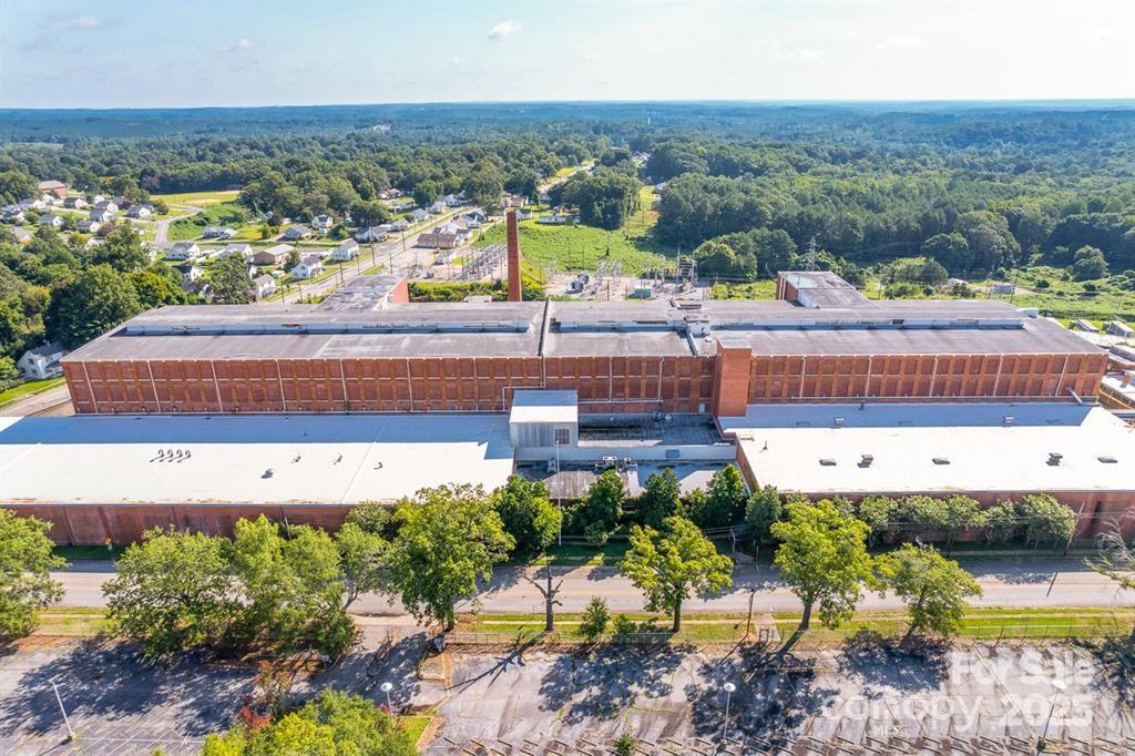 Incredible Industrial or Redevelopment Opportunity. This historic Monarch Mill building creates an outstanding redevelopment opportunity as well as industrial space.   
With 700,000 sq ft of usable, well-maintained space spanning over 17 acres, this property is a rare find in the current market. Strategically located between Charlotte, Greenville, and Columbia, it offers a great logistic advantage that enhances its appeal for businesses seeking efficient distribution channels.
The expansive footprint allows for a variety of potential applications, including manufacturing, warehousing, or innovative mixed-use developments that blend residential, commercial, and recreational spaces. The building's solid infrastructure features modern utilities, high-capacity loading docks, and flexible floor plans that can accommodate diverse business needs.
Surrounding the mill, the vast acreage provides ample parking, outdoor storage, or the possibility for further expansion.
