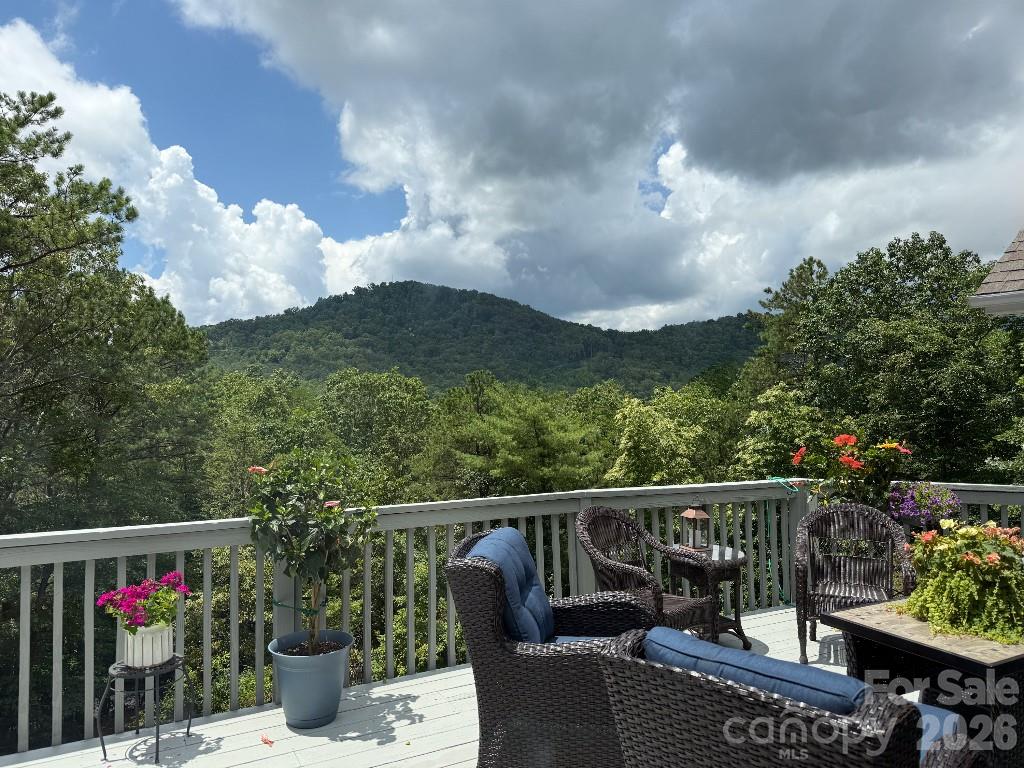 An expansive view of local mountains and an ideal location in the heart of Black Mountain.  All year around views are visible from the sunroom, living room, dining room, den, primary suite, and the large deck.  Feels secluded yet the Black Mountain golf course is just down the hill. 5 minutes to downtown Black Mountain, Lake Tomahawk, and Montreat. 

Features include complete remodeling of the 2 main level bathrooms, oak hardwood flooring covering the entire main level, kitchen cabinet lighting, front porch remodel, asphalt paving for the very large parking areas, and new, multi-tiered landscaping.  The large deck was repainted in the spring. The water heater and HVAC system were replaced in January, 2025 with the most efficient products available; a Heat Pump based water heater and a Mitsubished Hyper Heat System for heat and air.

Each floor level has its own entry door and an indoor privacy door is available between levels making it possible to rent one or two levels independently.