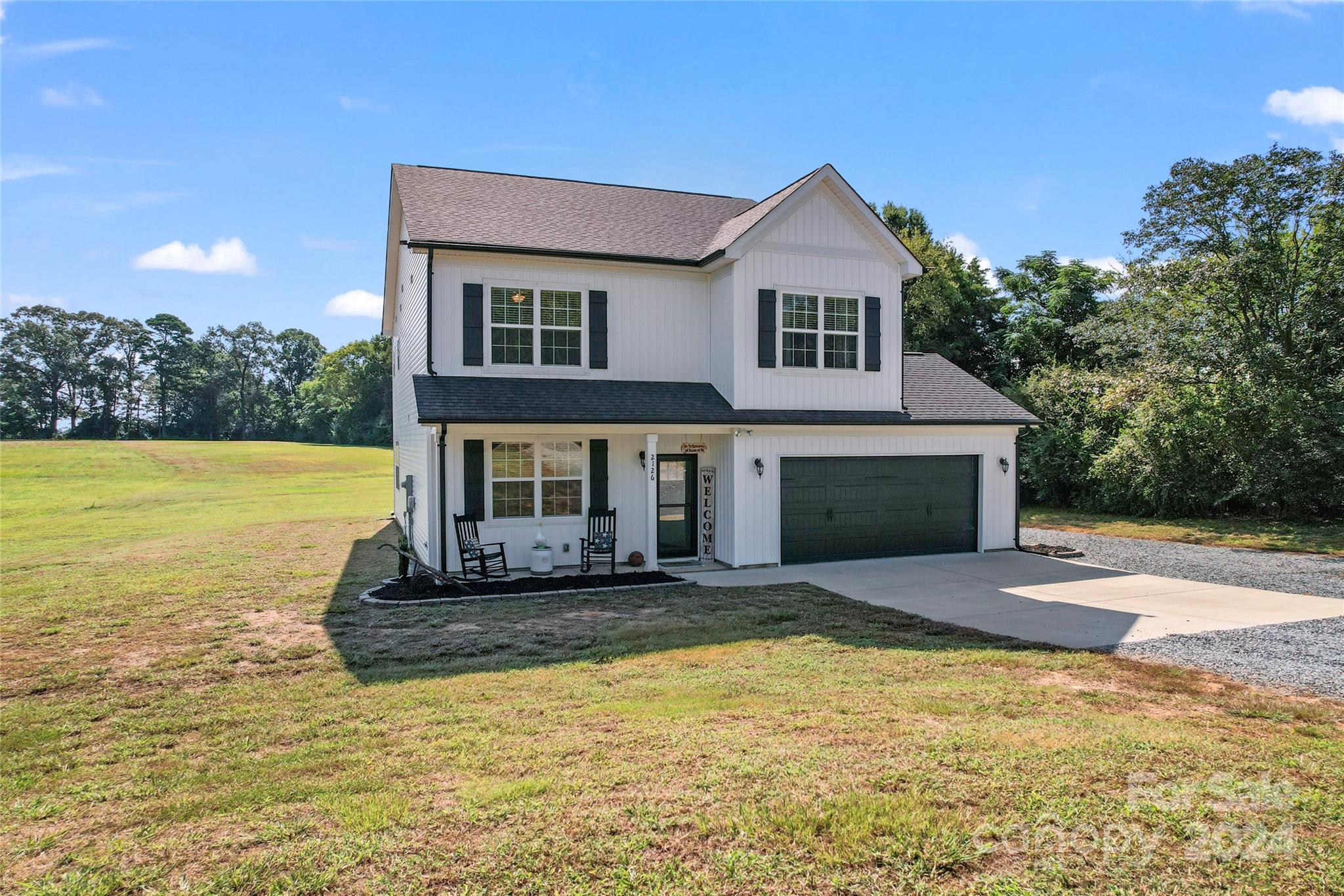 Welcome to country living at its finest with this stunning white Board & Batten home situated on 1.83 acres of picturesque land! Rustic elegance greets you as you drive up to find architectural shingles, black gutters, shutters, & garage door. Step inside to find a modern but cozy aesthetic with LVP flooring throughout the first floor, &  an open concept kitchen with granite counters, stainless steel appliances, & a breakfast bar - perfect for preparing meals while entertaining guests in the spacious family room with a stunning gas fireplace. As you make your way upstairs, you'll discover a luxurious primary bedroom & bath featuring granite counters & an oversized step-in shower - the perfect spot to unwind after a long day. Three additional bedrooms with large closets are perfect for accommodating family or overnight guests, while the conveniently located laundry room adds an extra level of efficiency. The rear patio completes the home & makes enjoying quiet country nights easy!