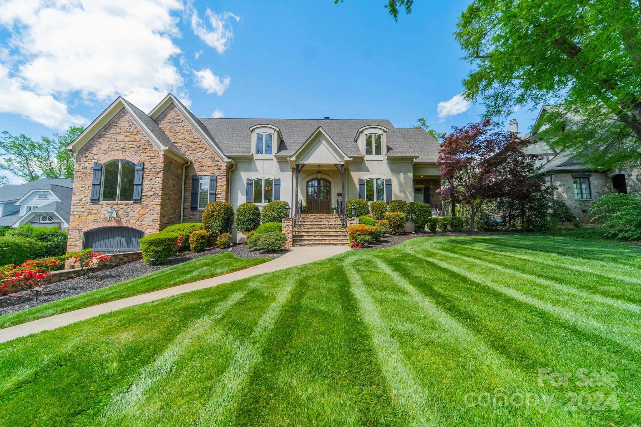 Elevate your lifestyle in this stunning home offering the timeless allure of high ceilings, graciously sized rooms accentuated by 8-ft doors & gleaming hardwoods. Primary on main provides a serene retreat w/spa like bath & 2 generously sized closets. Gorgeous kitchen designed to inspire & enhance your culinary experiences, bathed in natural light featuring Calacatta Gold quartz countertops, Viking & Sub-Zero appliances. 5BR & 5.1BA delivers ample space for family & guests. Covered rear porch makes the perfect setting for al fresco dining or enjoying tranquil evenings overlooking the lushly landscaped grounds & pool. Indulge your passion for fitness in the private gym on the lower level, or simply relax & unwind in the saltwater pool. Entertaining is a breeze w/ a second kitchen in the pool/guest house. Add'l features include an elevator for easy access to all levels, 3 garage spaces, & a private porch off the study for moments of quiet contemplation. Welcome Home!