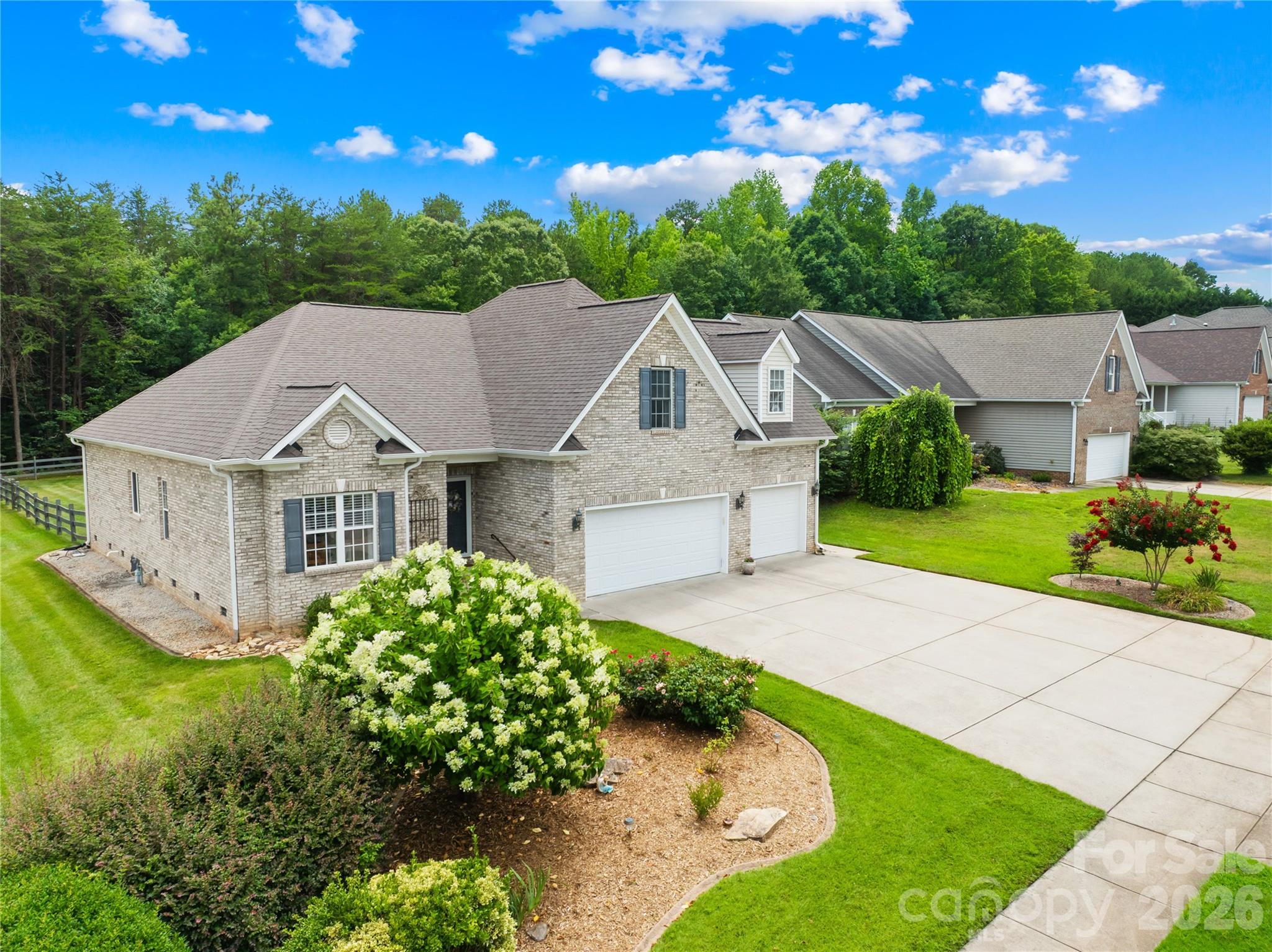 Sought-after, all-brick ranch-style home featuring 4 bedrooms, 3 full baths, and an impressive 3-car garage! The main level boasts a light and bright open floor plan with high ceilings, gleaming hardwood floors, and fresh Sherwin-Williams Cashmere paint. Gather in the soaring great room, complete with a cozy corner gas-log fireplace and a mounted OLED TV that stays with the home.

The beautiful kitchen features white raised-panel cabinets, solid-surface countertops, a wall oven, electric cooktop,  custom tiled backsplash, and stainless steel appliances. Storage is a breeze with a massive walk-in pantry and a huge laundry room. The primary suite and two additional main-floor bedrooms all feature elegant tray ceilings. In the primary retreat, you'll find a large walk-in closet with automatic lighting and an en-suite bath with dual vanities, a soaking tub, and a separate shower. The front bedroom window is flanked by shelving perfect for books or collectibles. Upstairs offers ultimate flexibility with a large bonus room, a full bath, and a 4th bedroom.

Work from home? AT&T fiber provides high-speed internet! 

Car enthusiasts and hobbyists will love the pristine 3-car garage. Step outside to a large, fully fenced backyard featuring an oversized patio, a Sunsetter awning, and a beautiful pergola overlooking a peaceful wooded backdrop. The neighborhood features a community pond—perfect for kayaking, canoeing, or fishing!  Located just minutes from Daveste Vineyards, Lake Norman State Park, and the charming town of Troutman. 

Recent Upgrades & Updates:

New architectural shingle roof (2024)

Fresh Sherwin-Williams Cashmere paint throughout (2025)

Engineered hardwood flooring was added to the main-level bedrooms, all bathrooms, laundry, and pantry, to match the original hardwood floors (2025) 

New electric water heater (2025)

New upper-level Bosch Heat Pump system (Air Handler & AC) installed by Troutman Sheet Metal (2025)

New Whirlpool refrigerator (2025)

Several pieces of furniture are negotiable or can remain with the home. Ask for specifics.