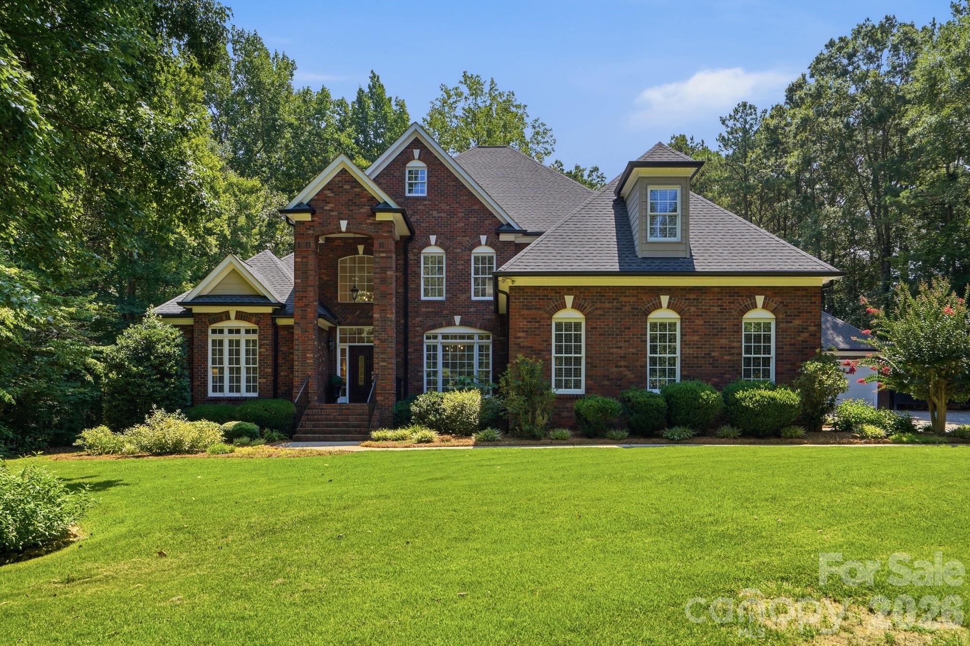 There are homes that check every box, and then there are homes that make you never want to leave. Nestled on a beautifully landscaped, private one-acre homesite in the sought-after Oxford Place community, this exceptional custom home offers the perfect blend of timeless elegance, everyday comfort, and resort-style living. From the moment you arrive, the picturesque setting, mature trees, and welcoming curb appeal create an unforgettable first impression. Inside, thoughtfully designed living spaces flow effortlessly, offering formal and casual gathering areas, a stunning chef's kitchen, beautiful cabinetry, spacious living areas anchored by beautiful fireplaces, and a main-level primary suite designed as a peaceful retreat. Step outside and discover what truly sets this home apart. Your backyard is a private oasis featuring a heated saltwater pool and spa, lush professional landscaping, expansive outdoor living spaces, and room to entertain, relax, and create memories year-round. Whether hosting summer gatherings, enjoying quiet mornings with coffee, or ending the day under the Carolina sky, every space has been designed to embrace the lifestyle you've been dreaming of. With five bedrooms, 4.5 baths, over 4,100 square feet, an attached and detached garage complete with a created gathering spot, and a rare one-acre homesite, this home offers the space and flexibility today's buyers are searching for. Located just minutes from award-winning Fort Mill schools, shopping, dining, and convenient access to Charlotte, this is more than a home; it's the lifestyle you've worked for. Welcome to your forever home.
