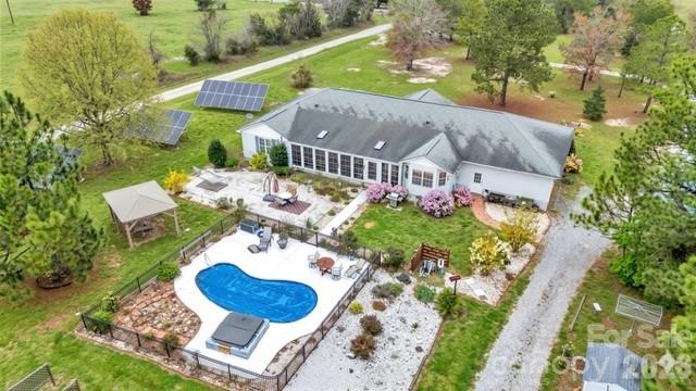 Don’t miss this rare opportunity to own a private 4.2-acre oasis just minutes from downtown Cheraw and bordering the
state park! This move-in-ready home is loaded with high-value upgrades and immediate energy savings—fully paid,
transferable solar panels (average electric bill only $24/month!), newer roof, newer heat pump, and freshly repaved
driveway. Step inside to a bright, spacious open floor plan featuring 4 bedrooms, a convenient Jack & Jill bath, wide 36”
doorways, an oversized walk-in pantry, charming dining-room window seat, and a heated/cooled sunroom that overlooks
the sparkling saltwater pool—perfect for year-round enjoyment. Outside, enjoy irrigated fruit trees and berry bushes, a
heated/cooled 2-car garage ready for your workshop, additional storage shed, dry crawlspace with transferable termite
bond, and plenty of room to spread out on your own 4.2 acres. 
Rare financing incentives available: preferred lender offering additional buydown/closing cost credit! Priced to
sell FAST and truly turn-key. Schedule your private showing today—this one will be gone before you know it! 1035 McMillan
Rd – Your private retreat awaits!