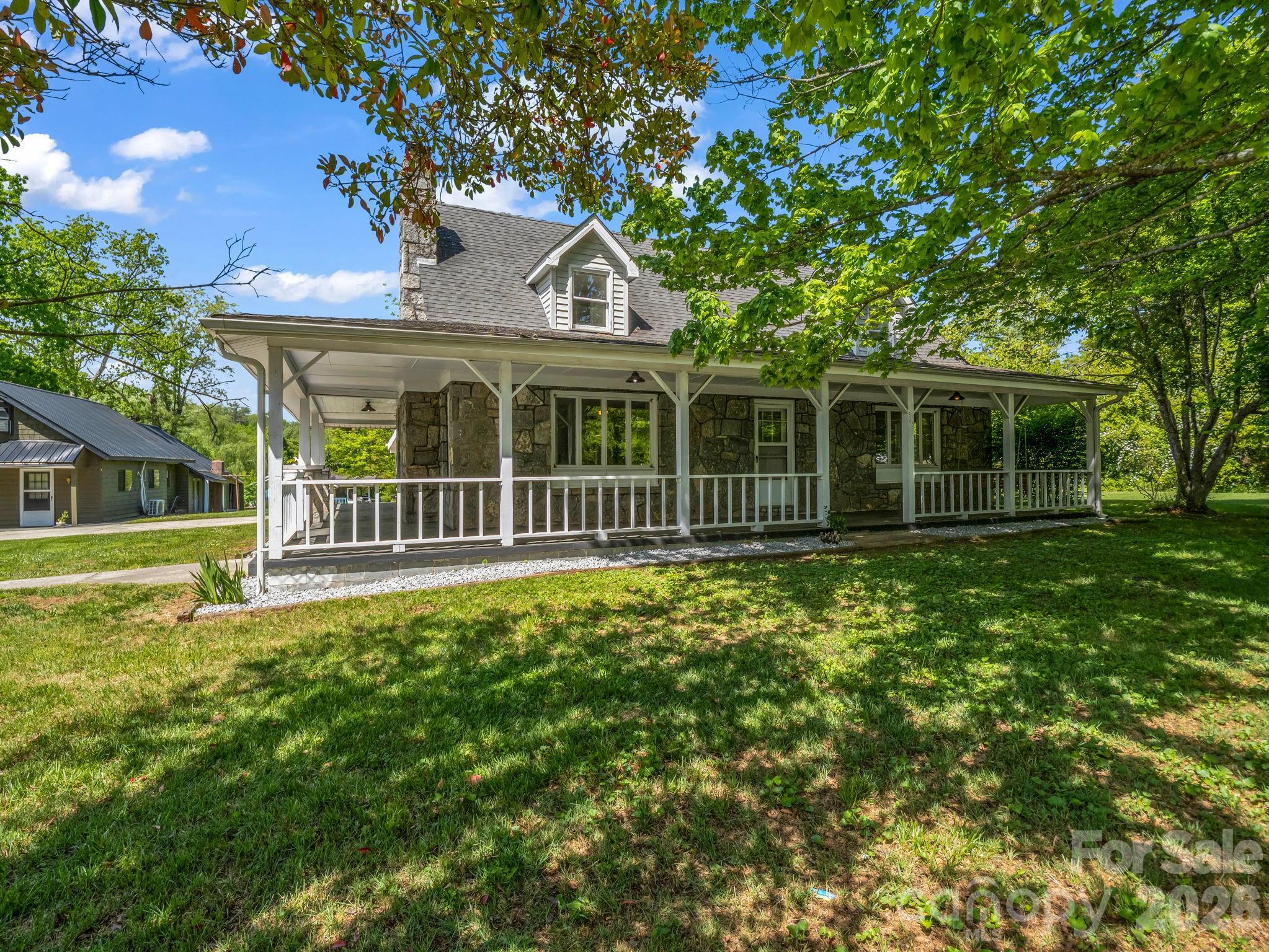 Some homes just have a soul, and this rare Hendersonville treasure is one of them. From the moment you pull up, the enduring strength and timeless beauty of the custom 1947 granite farmhouse grounds you in history. Step across the threshold into an inviting sanctuary of warmly defined spaces, where rich wood finishes and rugged stone accents wrap you in immediate comfort. With over 2,300 sq. ft. of living space, the thoughtful split-bedroom layout offers a quiet, private sanctuary to retreat to at the end of the day.

The magic truly unfolds as you move outside onto your sprawling 1.34-acre estate. Picture crisp Carolina evenings filled with the crackle and glow of your backyard fire pit, starlit skies, and the sheer freedom of a massive, level lawn. Beyond the vintage charm lies an incredible gift for your future: a newly surveyed and strategically subdivided rear lot of 0.42 acres(Lots 1 & 3 included). It provides a canvas whispering with potential for a detached guest house, a creative workshop, or a multi-generational family compound. Feel the craftsmanship, embrace the space, and start building your legacy here. (Note: Listing includes main house and rear lot; adjacent duplex is excluded but available in a separate listing of the entire compound)