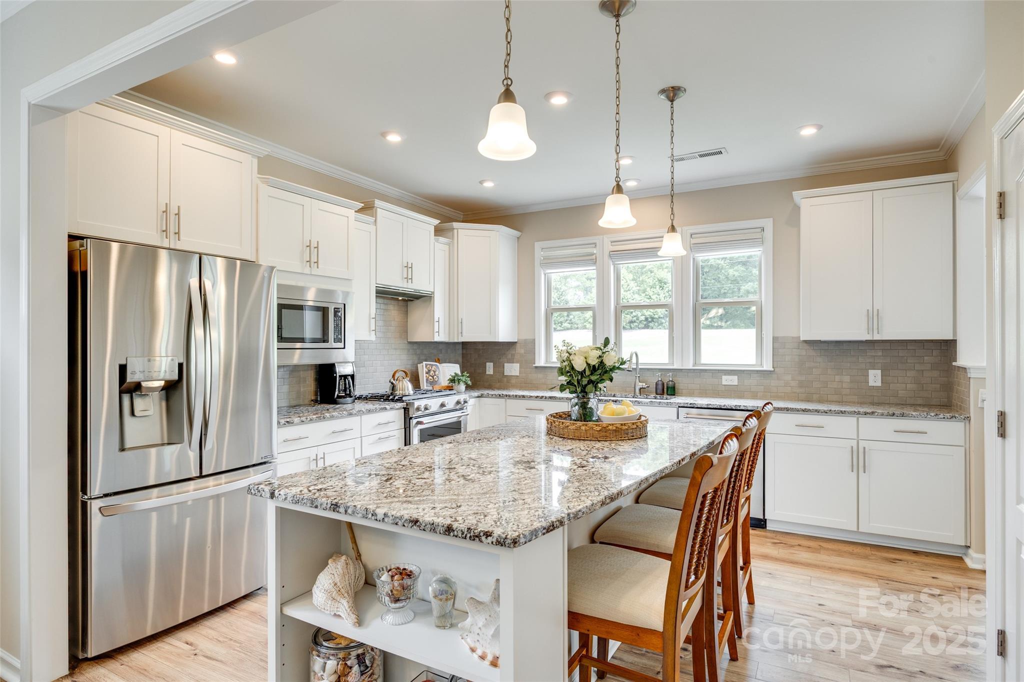 Unmatched quality, this better-than-new Carolina Orchards 55+ community home is seeping w/ charm! A relaxing front porch greets you as you make your way in on stunning LVP floors that run throughout the downstairs common areas. The kitchen is sure to impress w/ gas range & expansive island, & sunroom looks onto the flat & fenced yard, w/ close to 300 sqft of paver patio! In the primary suite you'll enjoy a tray ceiling, walk-in tiled & frameless shower, dual sinks, & more! Rounding out the downstairs is a guest bedroom & bathroom, & office. The upstairs adds space & flexibility, w/ a loft, bedroom, & ensuite bathroom. Storage abounds w/ large closets throughout, & even a walk-up attic from the oversized garage (w/ sink & tankless hot water heater). Carolina Orchards is a conveniently located, lifestyle rich community, w/ indoor & outdoor pools, fitness center, sport courts, dog park, full time activities director, & near the Anne Springs Greenway - enjoy the best years ahead in style!