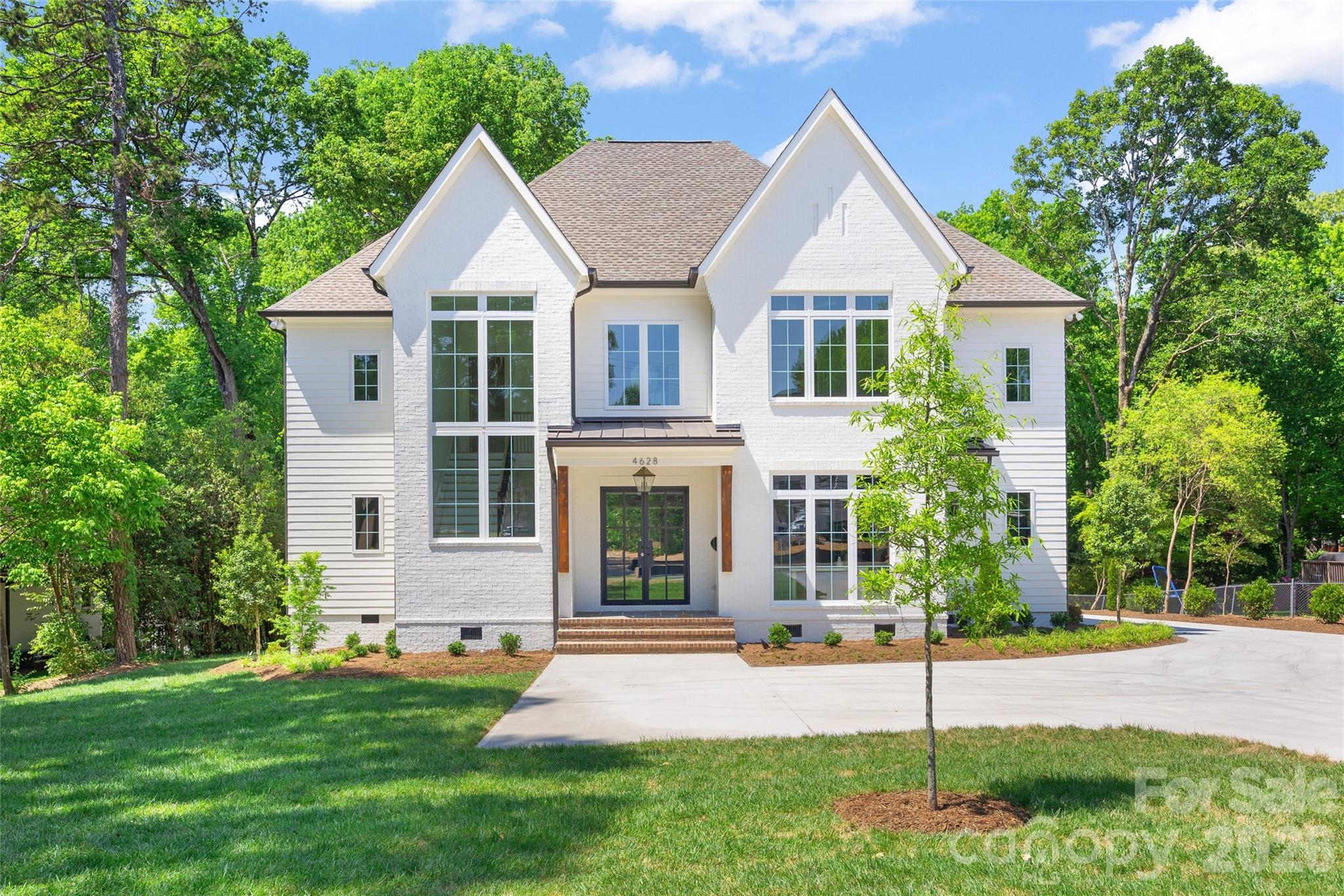 This exceptional custom home was drawn by acclaimed architect Robert Foster and built by Westwood Custom Homes. It offers a refined take on modern living in Charlotte’s coveted Cotswold neighborhood. A soaring two-story foyer makes an unforgettable first impression, setting the stage for interiors rich in natural light, custom millwork, and thoughtfully curated finishes throughout. At the heart of the home, the chef’s kitchen pairs bespoke cabinetry with a 46" dual fuel JennAir range and complimented by a stunning scullery with exceptional storage, a wine/beverage refrigerator, and a second dishwasher..perfect for supporting those that love to entertain. The Great Room, anchored by a wood-burning Isokern fireplace, opens to a covered outdoor living space with a gas fireplace and built-in grill, creating seamless indoor/outdoor entertaining that overlooks a serene wooded lot. The main-level primary suite is a private retreat, highlighted by a vaulted ceiling, an expansive walk-in closet with integrated washer/dryer, and a spa-caliber bath with soaking tub, dual vanities, and a zero-entry shower. A dedicated office with an adjacent full bath offers flexibility as a guest suite. Upstairs, three ensuite bedrooms, a full laundry room, and a versatile flex space with dry bar provide both function and flexibility. 



4628 Water Oak is a statement in elevated design and craftsmanship—delivering a seamless blend of luxury, livability, and resort-style indoor/outdoor living in one of Charlotte’s most sought-after enclaves.