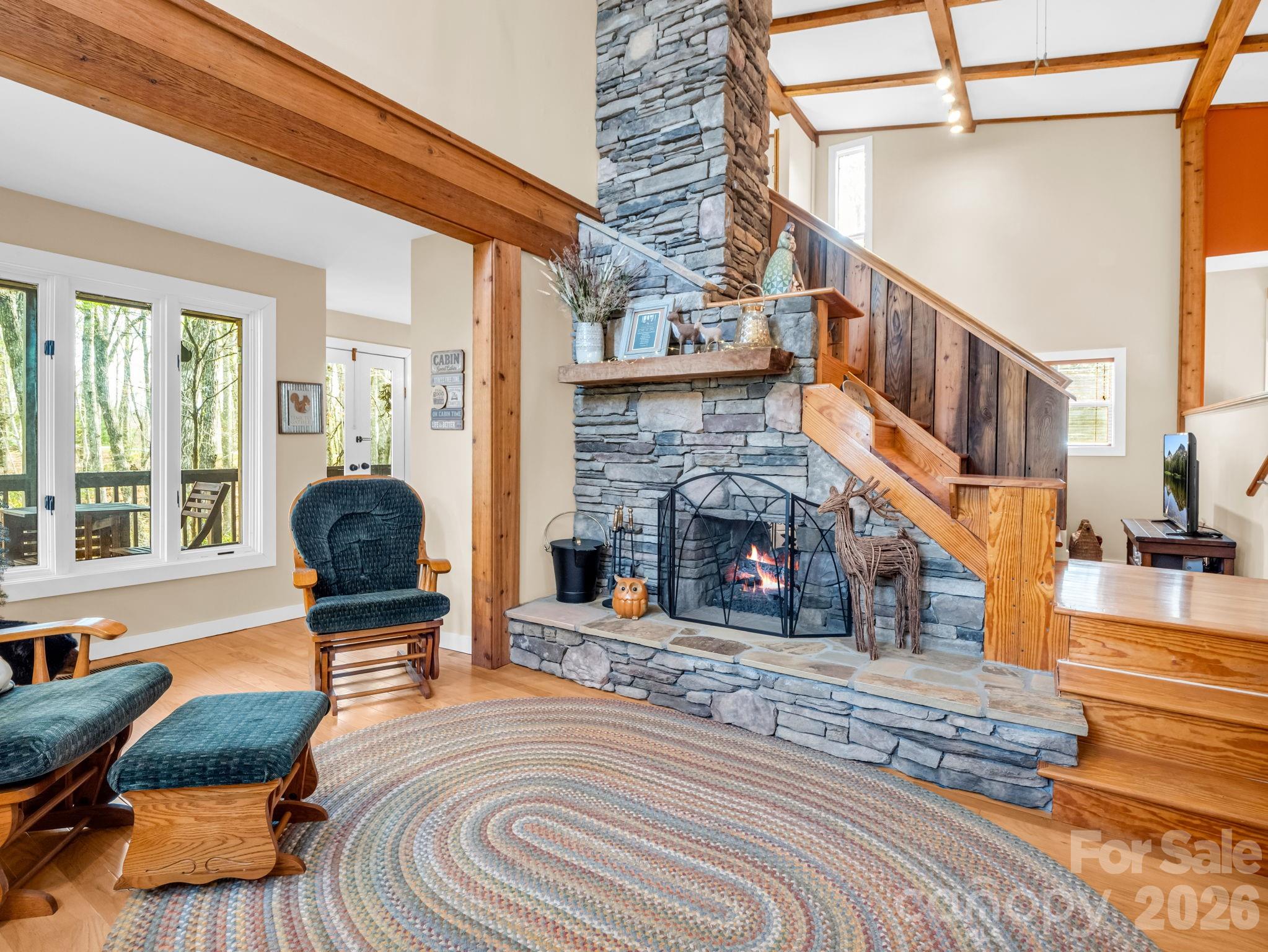 Welcome to an exceptional value in Connestee Falls—where quality updates at this price point are a rare find. Close to the East Fork Gate and a short drive to all Connestee Falls amenities, this home is a true haven for nature lovers. Enjoy morning coffee or evening gatherings on the expansive open deck, or relax in the large screened-in porch overlooking peaceful green space, where the sights and sounds of the forest surround you. The double-sided fireplace in the living room and family room creates a cozy place to relax on cooler mountain days.
The meticulously maintained home features a welcoming layout with a large primary bedroom with an updated en suite, laundry room, and guest bathroom on the main level.  In addition, two bedrooms on the second floor are ideal for guests or a private retreat. The unfinished basement, with a concrete floor spanning the home’s footprint, offers abundant space for a workshop and extensive storage, with convenient access to the level-entry driveway.
This home is in the coveted Connestee Falls Community which offers, one of the top-rated golf courses in North Carolina, four lakes, 20+ miles of hiking trails, tennis, pickleball, pool, two restaurants, fitness center, and clubhouse, all within this spectacular gated community.
Note: Connestee Falls POA has a buy-in amenity fee of $14,000 if paid at closing. Short-term vacation rentals are allowed, with a minimum 2-night stay. Buyer to check directly with the Connestee Falls Property Owners Association for details.
Whether you’re searching for a full-time residence or a mountain getaway, this property offers the perfect blend of tranquility, convenience, and value in one of Western North Carolina’s most sought-after communities.