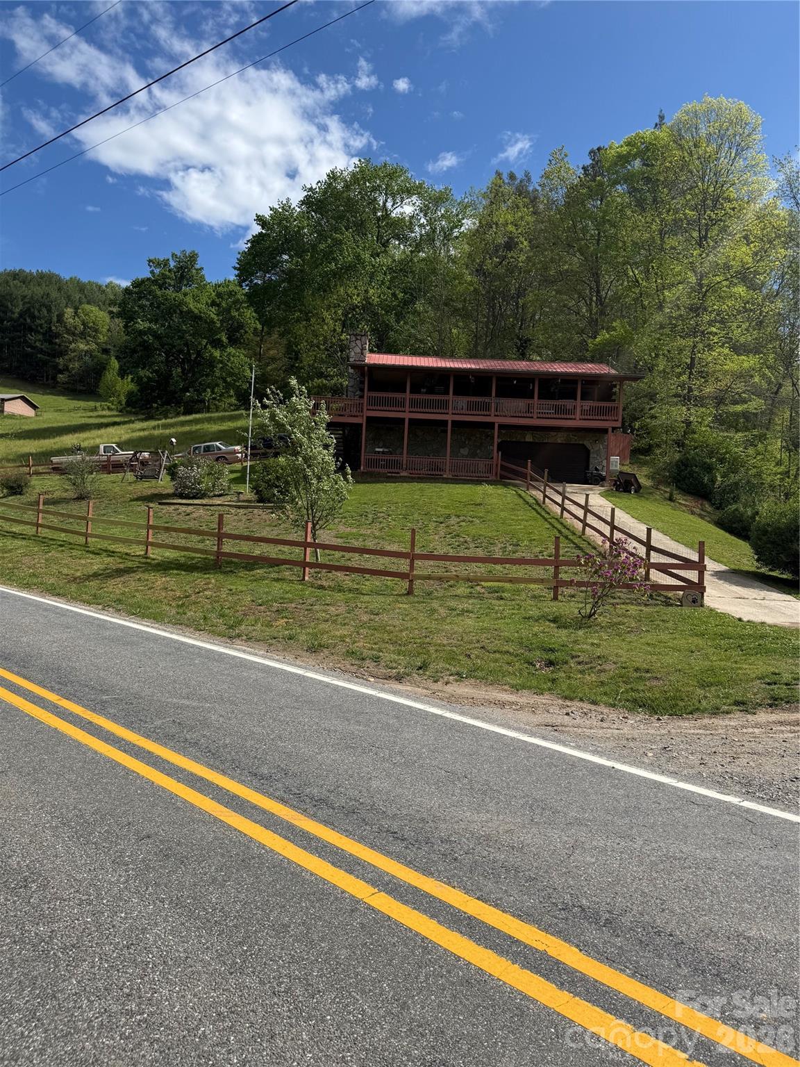 Beautiful Log Home in the Crabtree area of Haywood County! Home sits up on a hill overlooking the Pigeon River,. You can enjoy the view of the river and surrounding hillside views from your full length covered fron deck. Home is situated on !.2 acres. Also has a large storage building located  out from the home
Home offers 2 bedrooms and a 1 and half baths, a great room with high ceiling and a beautiful fireplace to enjoy those cool evenings.Home is located in tnhe beautiful Crabtree Community of Haywood County!
Home also has has a full basement which you could use as a workshop or craft area. Also, Home has a whole house generator. Steel workshop cabinets do not go with home.A must see!!