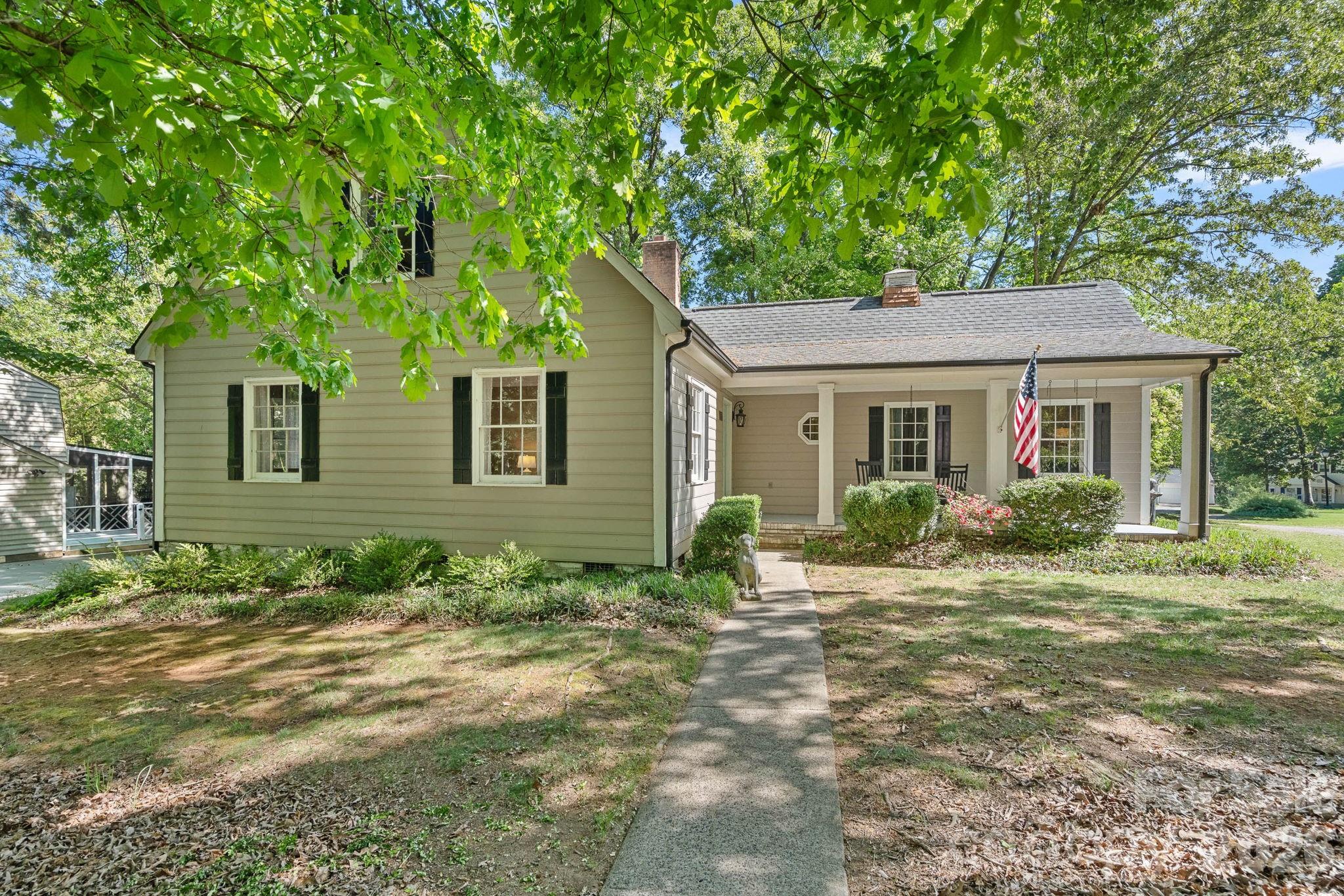 Tucked into a desirable Matthews location with no HOA, this charming 1.5 story 3 bedroom, 2 bathroom home offers almost 1700 heated square feet on a spacious corner lot of more than a quarter acre, uniquely positioned between two cul-de-sac streets. Inside, you’ll find inviting living spaces filled with character, including bamboo flooring, crown molding, a cozy brick, wood-burning fireplace in the family room, and a main level primary bedroom for added convenience. The updated primary bathroom adds a stylish touch with a frameless, tiled walk-in shower, upgraded vanity, and trendy tile flooring. Outdoor living is just as appealing, starting with the covered rocking chair front porch and continuing to one of the home’s standout features — the screened-in porch overlooking the backyard, perfect for relaxing or entertaining. A slate patio adds even more outdoor charm, all while being just 10 minutes from downtown Matthews. Living here you are less than 25 minutes from Uptown Charlotte.