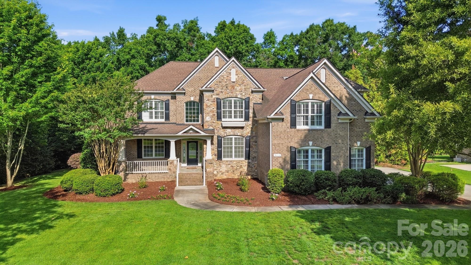 Located in desirable Marvin Creek this stunning full brick home with pond views, fully finished walk out basement, and freshly painted interior is ready for you to call home. Located on a premium .75-acre lot, a rocking chair front porch greets you. Step inside to find over 7400 square feet of living space! On the main level you will find a grand entry hall, a formal dining room with tray ceiling and a living room that leads to the two-story great room with floor-to-ceiling windows and gas fireplace. The great room opens to a spacious gourmet kitchen featuring a large island with a breakfast bar, granite counters, walk-in pantry, and a 5-burner gas cooktop. The kitchen opens to a bright and airy breakfast room, perfect for casual dining. The main floor also features the primary suite - a special retreat for the home owner featuring a tray ceiling, a sitting room, a double sided fireplace and a luxury bath with soaking tub, walk-in shower and generous size custom walk-in closet. A conveniently located laundry room and half bath completes the main level. On the upper level you will find a reading nook with built-in book shelves, a loft area with built-in desk, 3 generous size bedrooms, 2 full baths and a huge bonus/5th bedroom. On the lower level, the fully finished walk-out basement will make you never want to leave! This ultimate entertainment and relaxation zone includes a large rec room with fireplace, a flex room, full bath, fully equipped theater room, office, a game room, gym area, kitchenette with barstool seating and a storage/utility room. Other highlights include two separate staircases ensuring easy flow throughout the main and upper level, plantation shutters, custom built-ins and plenty of walk-in storage areas throughout. Enjoy outdoor living on the back patio with views of the manicured back yard, an outdoor kitchen, fire-pit and fireplace. Other exterior features include a 3-car side-load garage, large driveway with plenty of parking space and water views of the pond with fountain. Marvin Creek offers exceptional neighborhood amenities that include multiple pools with a lazy river and waterslides, clubhouse, basketball and tennis courts and walking trails.