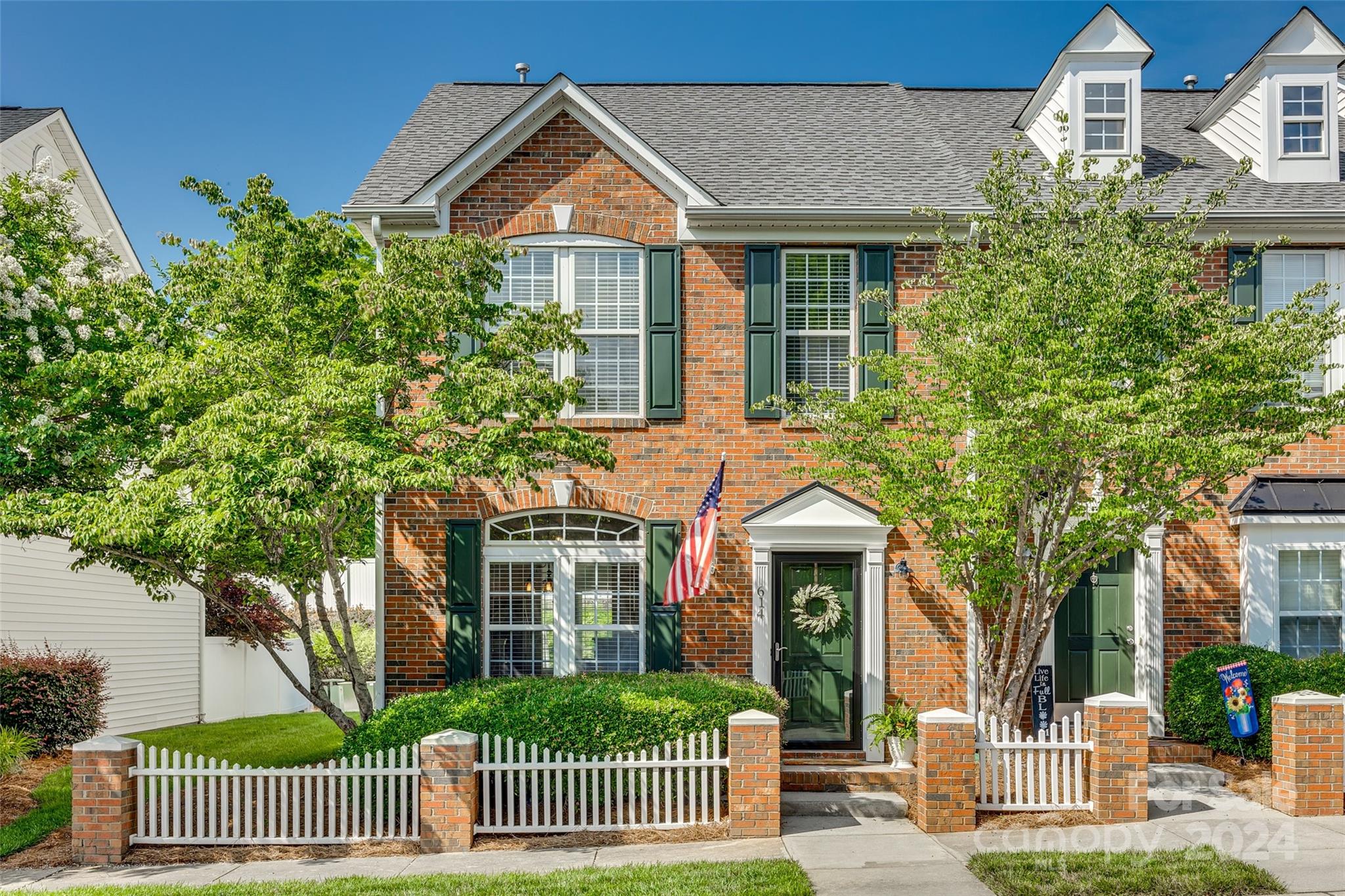 Adorable end unit townhome nestled amongst mature landscaping, street lights, sidewalks and picket fencing.  Kitchen features granite countertops, tile backsplash, dining area and extra bar seating. Great room with ceiling fan and lots of natural light. The second level boasts two spacious bedrooms with private baths. Primary ensuite with large walk in closet and bath featuring shiplap accent wall and updated vanity. New paint throughout the home. Back patio has plenty of room for entertaining and enjoying the outdoors.  Manchester Village features a community pool and clubhouse. Minutes away from I-77, shopping and restaurants.