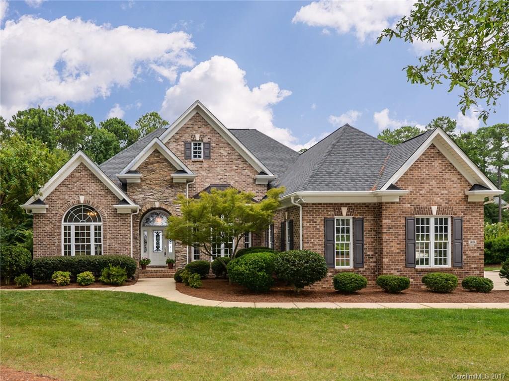 Prepare to be impressed with this full brick executive home nestled on .73 acres in desirable Water Edge. This custom built ranch home with a full basement is loaded with options! 11 foot ceilings on main level. Huge great room with vaulted ceiling. Stone fireplace. Tons of hardwoods. Heavy molding. Private master suite. Built in home vacuum. Screened porch. 4 car garage with HUGE space for workshop. Basement has bedroom & baths with possibility of incredible IN-LAW SUITE. Irrigation. Generator.