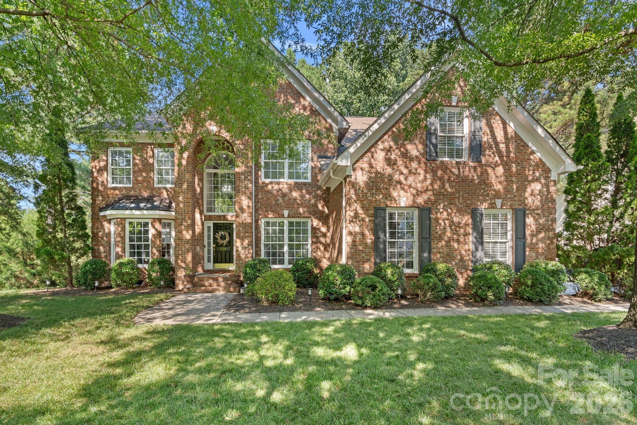 Welcome to this stunning full-brick 4-bedroom, 3.5-bath home in the highly desirable Lakeshore community! Beautiful hardwood flooring flows throughout the main level, complemented by brand-new carpet upstairs. The open-concept floor plan is filled with natural light and features a spacious great room with a cozy gas fireplace. The gourmet kitchen is designed for both everyday living and entertaining, offering a gas cooktop, abundant cabinetry, and a sunny breakfast room with a charming bay window overlooking the private, wooded, fenced backyard. Step outside to the expansive deck—perfect for relaxing or hosting guests. The desirable main-level primary suite provides comfort and convenience, while three additional bedrooms upstairs offer plenty of space for family and guests. The oversized walk-in storage area presents an excellent opportunity to create a fifth bedroom, home office, exercise room, or bonus space. Additional highlights include a side-entry 3-car garage and a new HVAC system serving the main level. Enjoy all the amenities of living near Lake Wylie with easy access to Charlotte, Uptown, shopping, restaurants, and recreation. This exceptional home offers the perfect combination of space, location, and lifestyle.