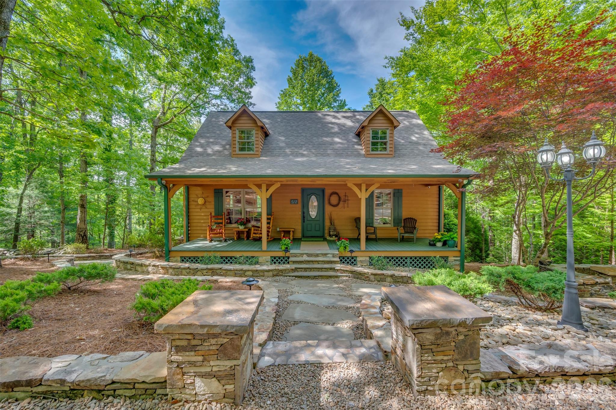 Escape to your own private mountain retreat! This amazing cabin is tucked away in the woods on 3.08 private acres, offering the perfect blend of rustic charm and peaceful living. From the moment you arrive, you'll fall in love with the incredible stonework, inviting covered front porch and serene natural setting. Inside, the stunning great room features soaring ceilings, warm wood finishes and an open loft overlooking the living area, creating the perfect cozy cabin atmosphere. Enjoy relaxing evenings by the fireplace or entertaining family and friends in the spacious open-concept living space. Step outside and experience true outdoor living with a beautiful screened back porch, outdoor fireplace and tranquil waterfall feature-all surrounded by nature. Whether you're looking for a full time residence, mountain getaway or vacation rental opportunity, this one of a kind property offers privacy, comfort and unforgettable charm. Winter views of South Mountains. A rare opportunity to own your own peaceful cabin retreat in the woods! An additional adjoining two tracts consisting of 5.69 acres and 3.09 acres could possibly be purchased. Roof new in Sept. 2025. Security system and cameras with Shelby Alarm.