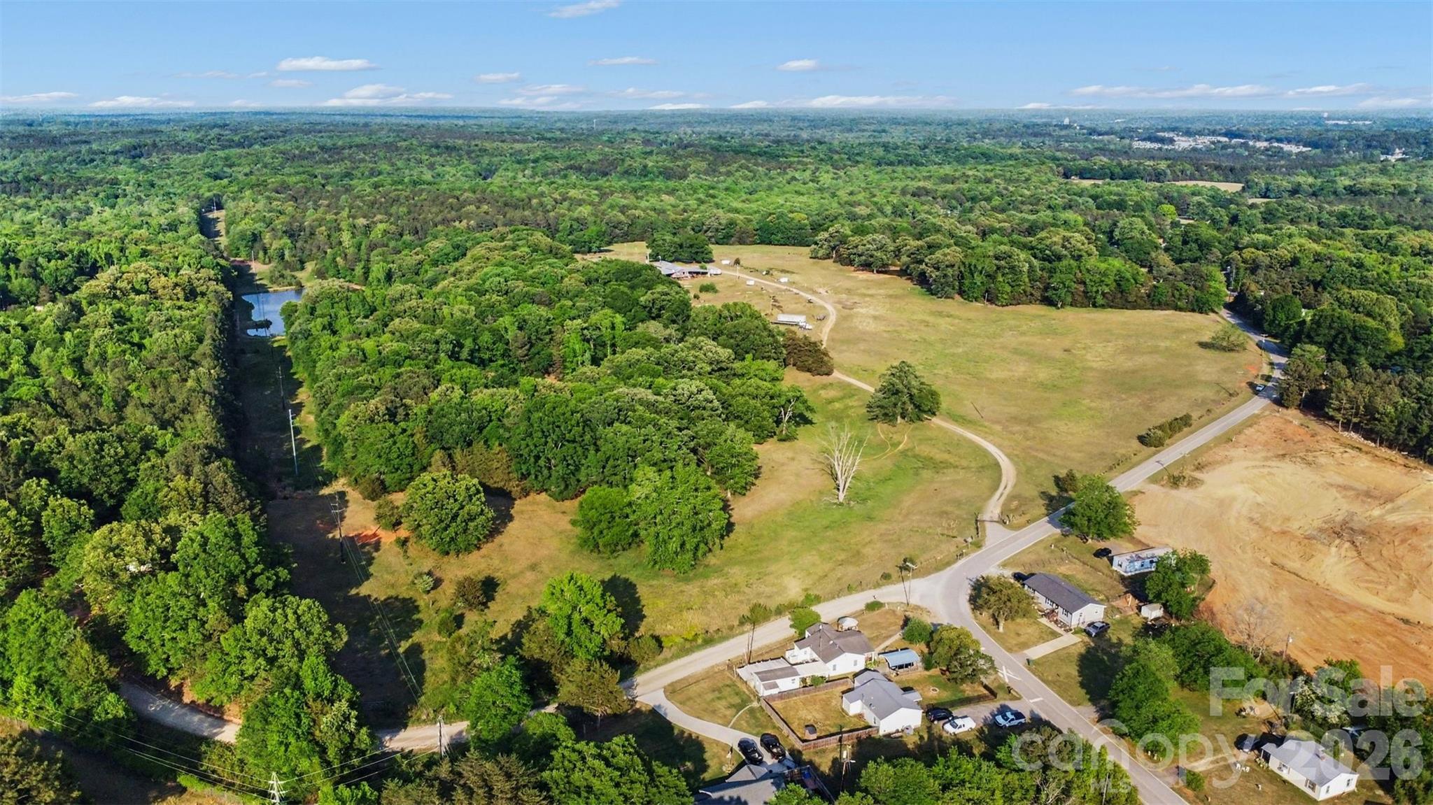 Unlock the immense potential of 1504 Cedar Pines Lake Road, a sprawling 74.46-acre parcel positioned directly in the high-demand path of progress within Lancaster County. This expansive tract represents a rare opportunity for strategic developers, land investors, or those seeking to establish a massive legacy estate. Currently zoned AR (Agricultural Residential), the property is perfectly suited for a high-end "mini-farm" subdivision or a low-density residential community. The land’s favorable layout and substantial road frontage provide a clear path for developers to carve out several large-acreage home sites, a product type currently seeing unprecedented demand from buyers relocating from the dense urban corridors of Charlotte and Rock Hill.

For the visionary buyer, this property offers incredible investment flexibility. The Agricultural Residential zoning supports the creation of a private dream compound while allowing the remaining acreage to be subdivided into smaller parcels to offset costs or generate immediate returns. The terrain offers a mix of usable topography that is ideal for cost-effective site preparation, road infrastructure, and home pad development. Additionally, any existing structures on the property may offer "grandfathered" nonconforming status for current footprints, providing a unique advantage for specific site layouts or renovations that modern setbacks might otherwise restrict.

The location of this 74.5-acre gem offers the perfect balance of "Rural Gold" tranquility and modern accessibility. Situated only 8 minutes from the heart of downtown Lancaster and USC Lancaster, the property ensures that essential amenities are never out of reach. For the regional commuter or developer, the site is strategically located just 25 minutes from the I-77 corridor in Rock Hill and approximately 45 minutes from Charlotte Douglas International Airport. This proximity to major employment hubs while maintaining a serene, rural character makes it a cornerstone opportunity for a multi-phase residential project or a long-term land-hold in one of South Carolina’s fastest-growing counties.

Rarely does a contiguous tract of this magnitude and versatility become available in the Cedar Pines Lake area. This property is market-ready for cash buyers, conventional financing, or specialized agricultural lending through Farm Credit and USDA-FSA programs. Whether you are looking to develop a signature neighborhood, invest in timber and land appreciation, or build a world-class family compound, this 3.2 million-square-foot canvas is ready for your vision.