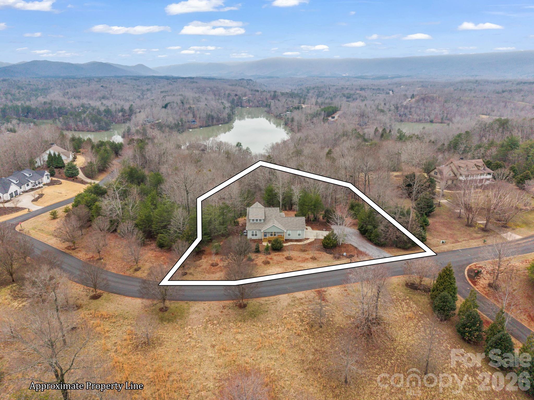Welcome to 631 Mountain Parkway, a stunning residence nestled within the gated Lake Adger Mountain Park neighborhood. Built in 2023, this newer home features three spacious bedrooms and three full bathrooms, perfect for family living or entertaining guests. The open-plan kitchen is equipped with beautiful granite countertops and sleek stainless-steel appliances, creating an inviting space for cooking and gathering. Enjoy the warmth of gas logs in the fireplace, ideal for cozy mornings or relaxing evenings. A versatile loft area offers the perfect setting for a home office or flex space. Best of all, a boat slip is included in the sale, making lake living even more enjoyable. Schedule a showing today to make lake life yours.
