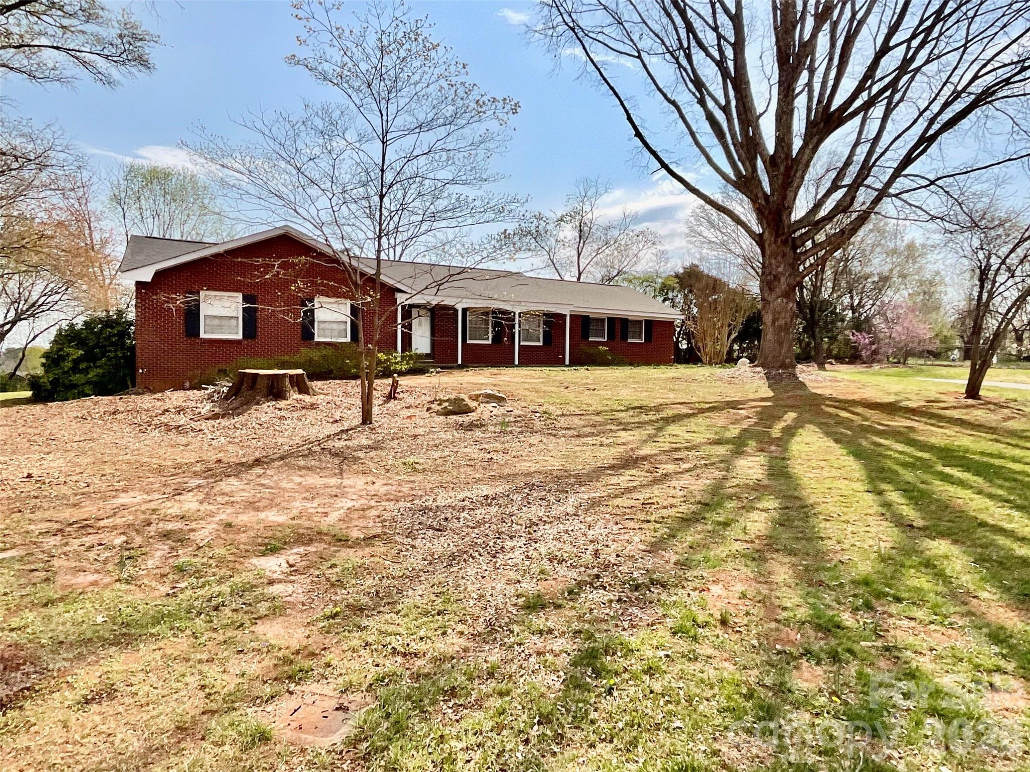 Charming full brick ranch nestled on a spacious 0.86 acre level lot in an established neighborhood with community access to beautiful Lake Hickory with boat launch and beach area. Full of character and timeless appeal, this home offers good bones, rare combination of convenience, outdoor enjoyment, and location. Recent updates include a new roof (2025) and newer HVAC, providing peace of mind for years to come. Inside, you'll find inviting living spaces along with a versatile sunroom/utility room that provides additional space for relaxing or everyday functionality. The property features a carport, wood fence backyard, and ample room for gardening and recreation. Rear yard was previously home to a pool but has since been filled in. Ideally located just minutes from Downtown Hickory, less than five minutes from the scenic Riverwalk, and only 45 minutes from Blowing Rock, you'll enjoy easy access to shopping, dining, entertainment, and outdoor adventures. Whether you're looking for a primary residence or a place to enjoy the Lake Hickory lifestyle, this home offers endless potential in a highly desirable setting. Caldwell County was unable to locate the septic permit on file; however, the septic system was last pumped in November 2025. Priced below tax and market value! This is your opportunity to make this home, your own or a great investment opportunity! This Home is in need of renovations, from minor to major to make it your own, renovate for rental or resale! AS-IS.