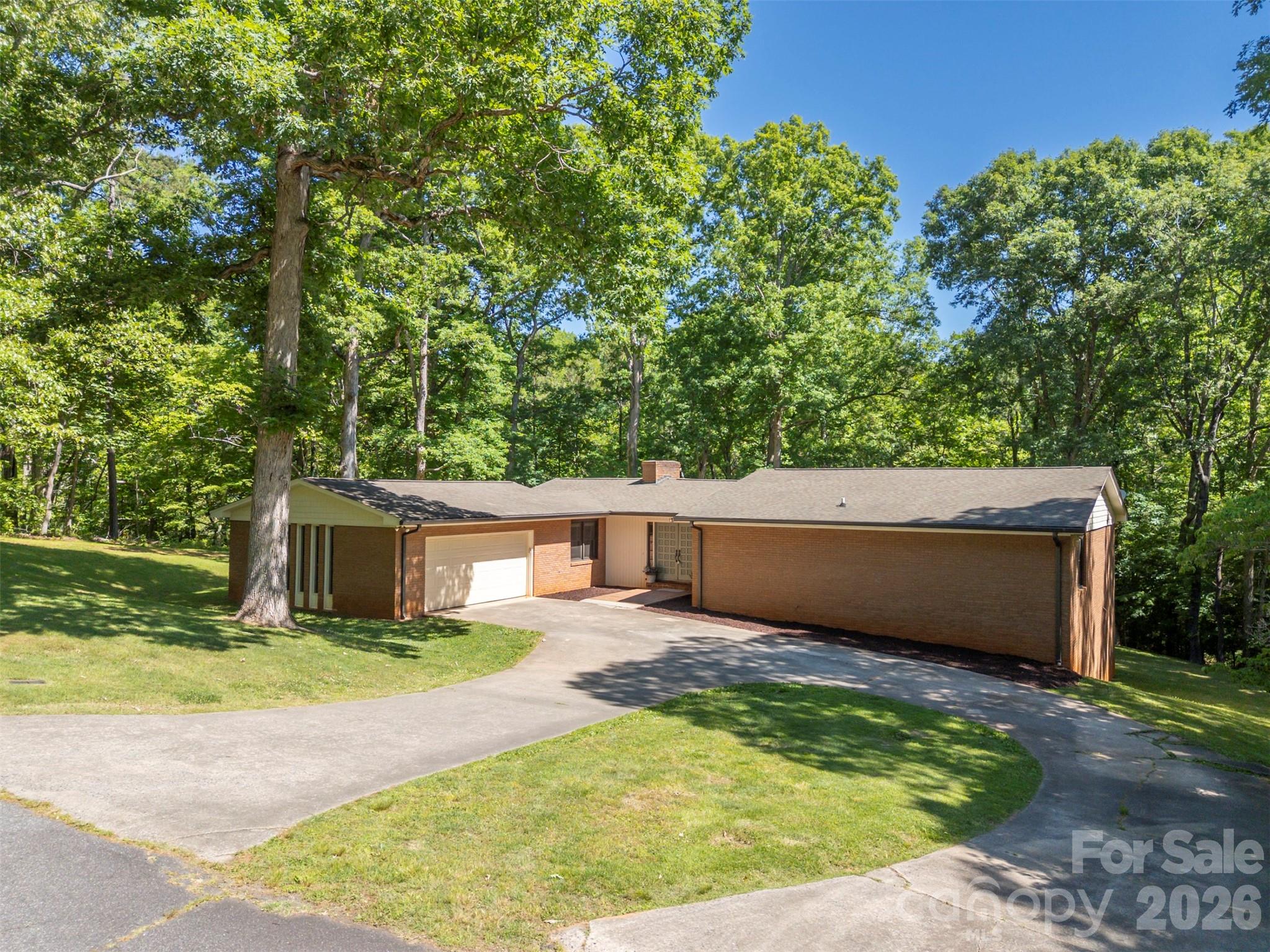 Tucked away on 1.19 private acres in a quiet cul-de-sac, this spacious brick home offers the perfect blend of comfort, character, and convenience. Located just minutes from downtown Forest City, you will enjoy easy access to local pubs, restaurants, shopping, and community events while still coming home to a peaceful, wooded setting. Inside, the main level features a large kitchen with a dining area, a formal dining room, and an inviting great room centered around a cozy wood-burning fireplace. The primary suite offers a walk-in closet and private bath, while on the main level, you will find two additional bedrooms and a full bathroom, providing comfortable space for family and guests. The lower-level apartment area creates endless possibilities for multi-generational living, guest accommodations, or entertaining. This versatile space includes a bedroom, bathroom, a den with a wood-burning fireplace, a billiard/entertainment room, and a dedicated storage area, offering ample space for hobbies, seasonal items, or extra organization. Outdoor living is just as impressive with a huge 672-square-foot deck overlooking the beautiful natural surroundings—perfect for relaxing, grilling, or hosting friends and family. A garage provides additional storage and convenience. With easy access to Charlotte, Spartanburg, and Asheville, commuting and weekend getaways are a breeze. This property delivers small-town charm with big-city accessibility—don’t miss your opportunity to make it yours!