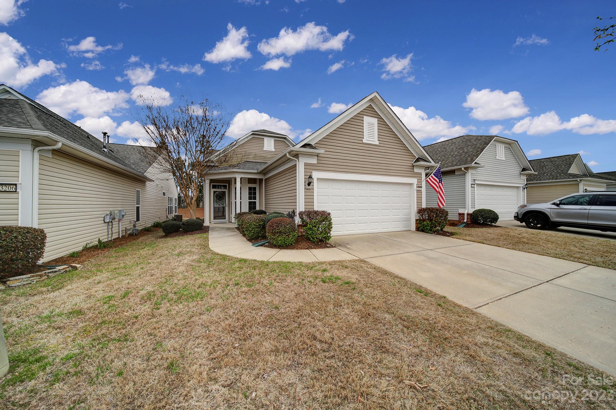 New LVP flooring & carpet in this Pine Spring home in Sun City Carolina Lakes! At the front of the home, French doors open to the study- ideal for a home office or hobby room! The open concept great room flows directly from the foyer into the dining area. The kitchen has addtional seating at the breakfast bar, as well as  granite counters, tile backsplash, stainless steel appliances & a breakfast nook with windows overlooking the backyard. The cheery sunroom sits just off of the kitchen with access to the back patio. The primary suite is at the rear of the home with an ensuite bath that has a dual sink vanity, glass shower, & spacious walk-in closet.  A guest bedroom with access to a full hallway bath is perfect for overnight visitors! Enjoy the fresh air on the spacious back patio with an electric retractable awning, while also enjoying the wooded view. Don't miss the many amenities at Sun City including an outdoor pool, club house, walking trails, tennis courts & more!