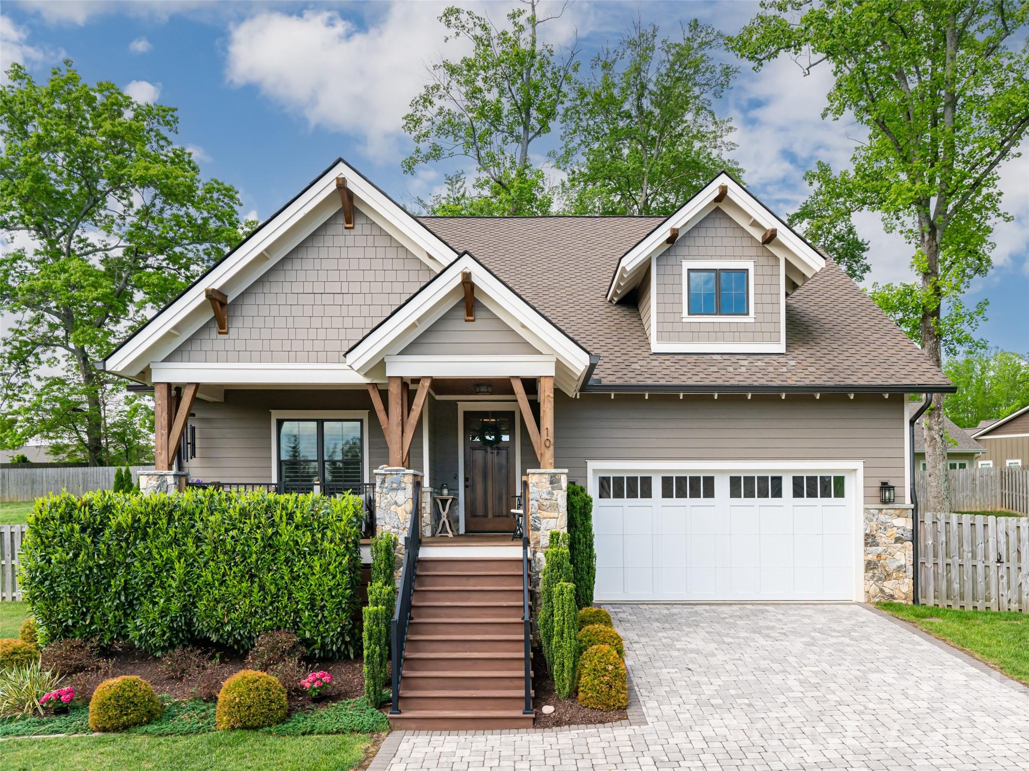 This bright, open-concept home perfectly blends high-end quality with everyday comfort. From the soaring foyer ceilings to the light-filled layout, it feels like home the moment you walk in. The chef’s kitchen is a standout, loaded with custom cabinetry, granite countertops, and premium Viking appliances. Relax by the cozy stone gas fireplace with its rustic barnwood mantle, or retreat to the oversized primary suite featuring a spa-like soaking tub, tile shower, and huge walk-in closet. Two additional guest bedrooms share a full bath. Outside is your own private oasis: a covered porch, paver patio with a built-in firepit, and a fully fenced yard. Bonus: it features an ultra-efficient dual-fuel HVAC system to keep utility bills low. Best of all, the sale includes the adjacent building lot (#102) for a total of 0.62+/- acres! Use the extra space for ultimate privacy, an ADU, a workshop, or a garden. This unique property offers endless possibilities.