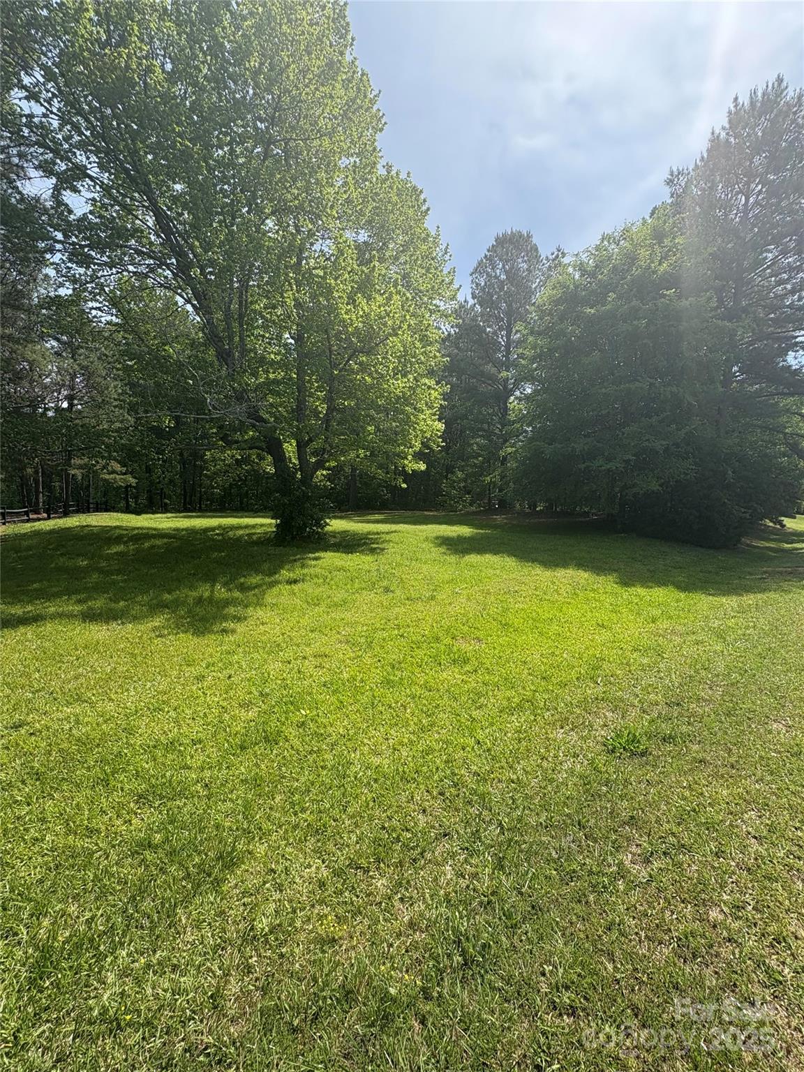 Don’t miss out on one of the most picturesque properties available in the sought-after Clover School District! This gorgeous, wooded parcel offers a gentle slope, providing the perfect setting for your dream home. Nestled across from a charming family farm and backing up to serene woods, this lot combines beauty with privacy. With light deed restrictions, and no HOA, you’ll have the freedom to create the perfect home. Embrace the beauty of country living while staying conveniently close to Lake Wylie and Charlotte.