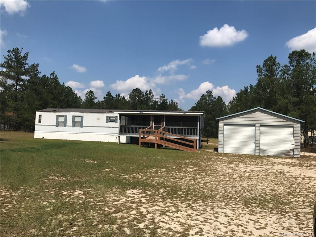Being sold "AS IS" 1997 16x70 mobile home on 2 acres. Double garage, carport, and shed. Also has a front screened porch. Master with walk-in closet, garden tub, separate shower and double vanity. All appliances to remain! Lots of privacy in a country setting.
