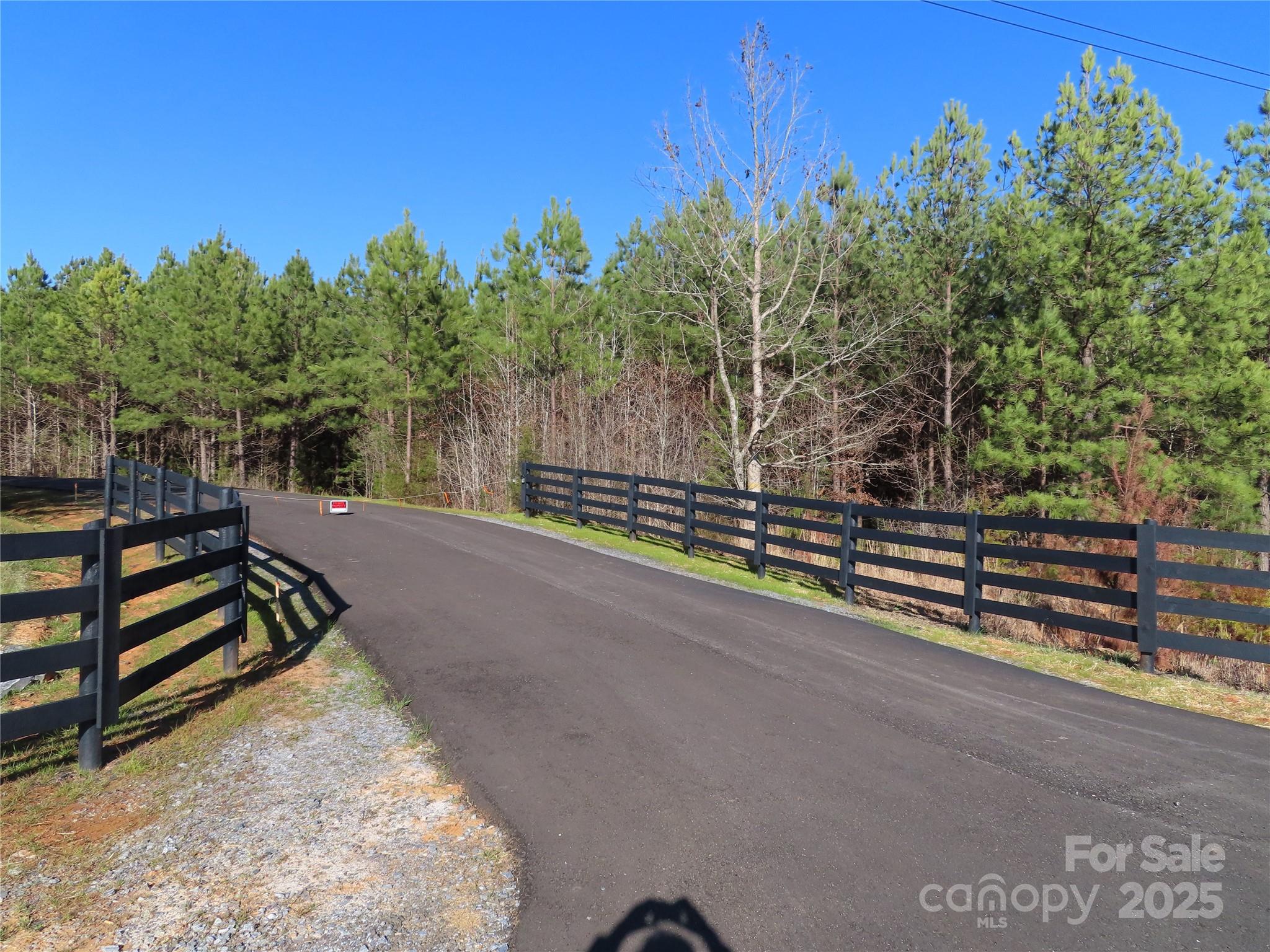 Located on a private driveway with large land tracts ( only 4 tracts), you will love  coming home to quiet peaceful living. Located about 8 miles west of York off Hwy 5. With hwy 5 being a 4 lane road the commute will be easy. Also located about 10 miles to I-85. The potential home site has been cleared and the land perked for a 4 bedroom house. Per the county the land can't be split any further. On the left side on the paved drive there is 7.2 acres and the remainder of the land is on the right side side of the paved driveway. The 7.2 acres also runs to the creek. It would be a great place for a nice workshop, Barn or another house. The county says 2 houses can be put on the property but one has to be 50% smaller than the other one.  The land is located beside 3828 Black Hwy, York SC 29745 ( see the black board fence). 
 You can't drive by it as it has a cable across the driveway. Appointment required.