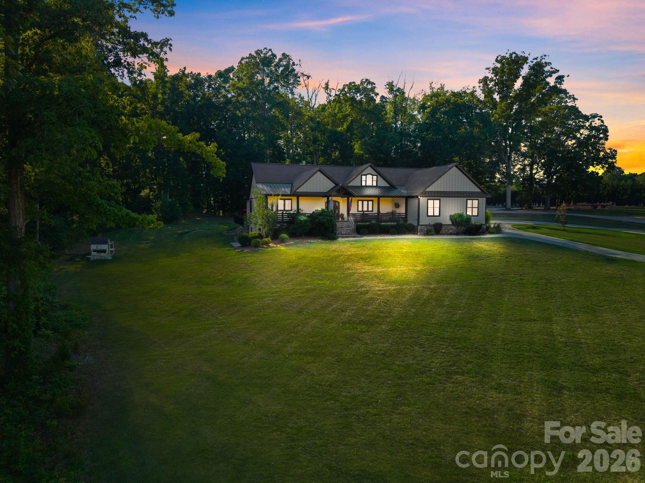 Welcome to the home you’ve been dreaming about. Set on just under 10 acres, this custom-built property offers the kind of space, privacy, and lifestyle that’s hard to find. From quiet mornings on the front porch to summer afternoons by the pool and holidays spent gathered with family and friends, this is a home designed for making memories. Thoughtfully built with custom finishes throughout and plenty of room to grow!
A wrap-around driveway provides ample parking and leads to a welcoming front porch overlooking the property. Inside, you’ll find custom finishes throughout, abundant natural light, custom French doors, wide-plank oak character flooring, vaulted plank ceilings, and a floor-to-ceiling stone fireplace anchoring the main living area.
The kitchen was designed for both everyday living and entertaining, featuring custom cabinetry, a built-in industrial refrigerator with beverage cooler, built-in ice maker, farmhouse sink, pot filler, oversized island, quartz countertops, large walk-in pantry, and a custom dining table that conveys with the home.
The primary suite offers outdoor access, a tray plank ceiling, freestanding soaking tub, walk-in tile shower, double vanities with custom cabinetry and brass fixtures, and a large walk-in closet with custom shelving, washer & dryer and a large dressing/vanity area.
The split-bedroom floor plan includes two bedrooms connected by a Jack-and-Jill bath, two additional bedrooms with access to a hall bath, and a bonus room over the garage with its own half bath.
From the 2-car garage, the mudroom offers functionality with a custom drop zone, extensive storage, utility sink, and pet washing station.
Outdoor living is just as impressive with a covered porch, multiple entertaining areas, and a saltwater pool featuring a tanning ledge, slide, and spacious pool deck.
The walk-out basement features a finished flex space currently used as a golf simulator, a full bath, and over 3,000 square feet of unfinished space. Already plumbed for a future kitchen, it offers incredible potential for multi-generational living, guest accommodations, an expanded entertainment area, home gym, workshop, or a private secondary living space.
Additional features include a whole-house Sonos sound system with indoor and outdoor speakers, irrigation system, geothermal heating and cooling, custom cabinetry throughout, and extensive storage.
Properties offering this level of craftsmanship, privacy, and flexibility rarely come available. This is a MUST SEE in person to truly appreciate all that this home has to offer.