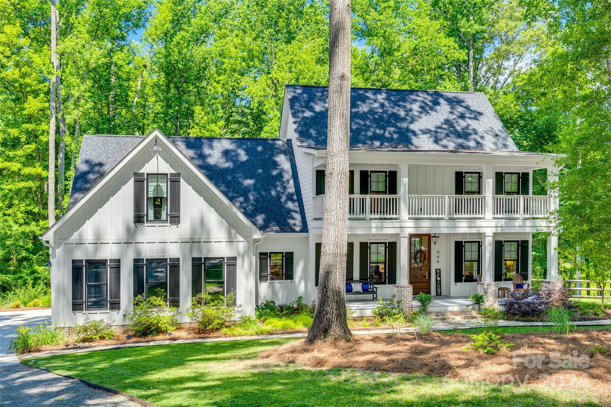 Newest home located on sought after Fairway Drive. Built in 2020 this custom home is located on the Fort Mill Golf course. The southern charm if this home is on 1.28 acres overlooking a canopy of mature oak trees. Upgrades throughout with beautifully stained, oversized French doors and wood floors reclaimed from a 100-year old Wisconsin barn. The chef’s kitchen boasts side by side commercial style refrigerator and freezer along with walk in pantry. The primary bedroom on the first floor has vaulted ceilings and direct access to the screened back porch. The primary bathroom shows off 2 walk in closets, side by side vanities and soaking tub. Four porches on the exterior of this home make for several opportunities to spend time overlooking the beautifully landscaped and fenced backyard. On the second floor you will find a large bedroom over the garage along with 2 additional bedrooms and bath. Fort Mill continues to create great quality of life with its many parks and top rated schools.